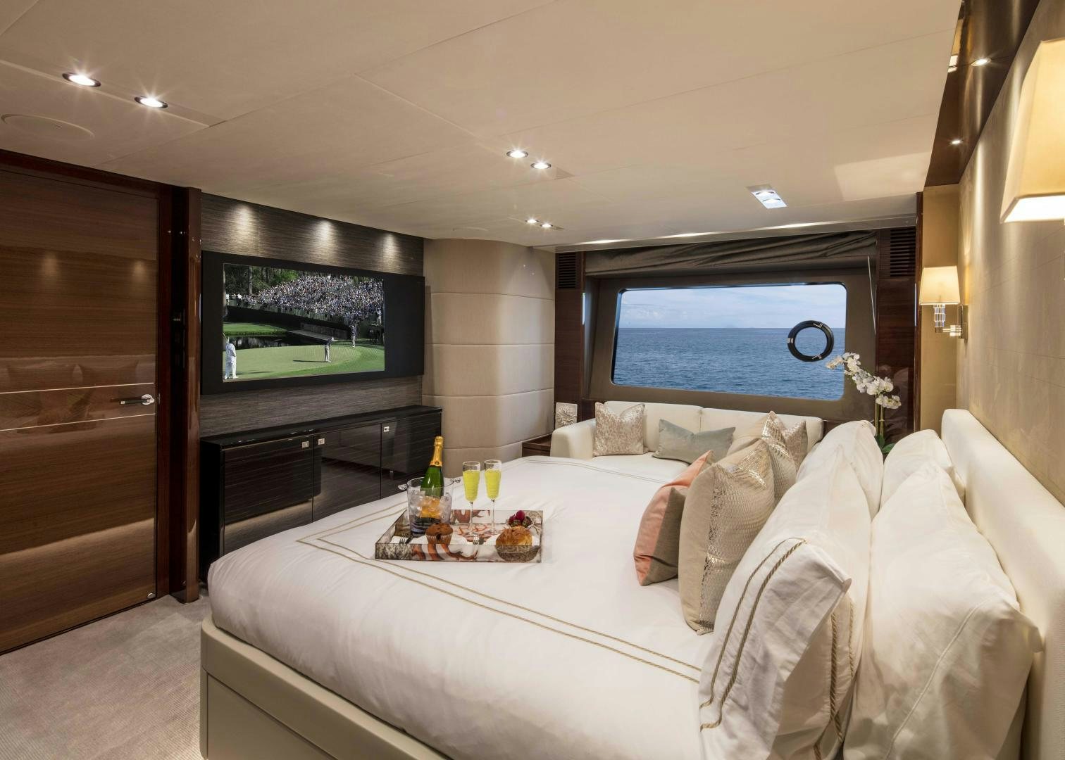 a bed with a white bed spread aboard HOT PURSUIT Yacht for Sale