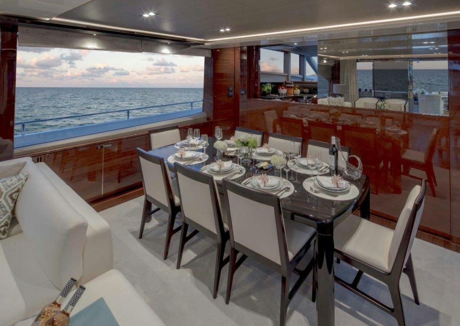 a dining room with a large window aboard HOT PURSUIT Yacht for Sale