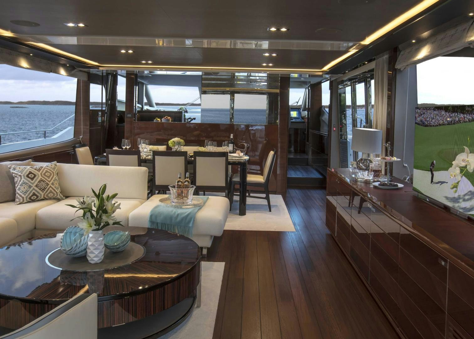 a room with a table and chairs aboard HOT PURSUIT Yacht for Sale
