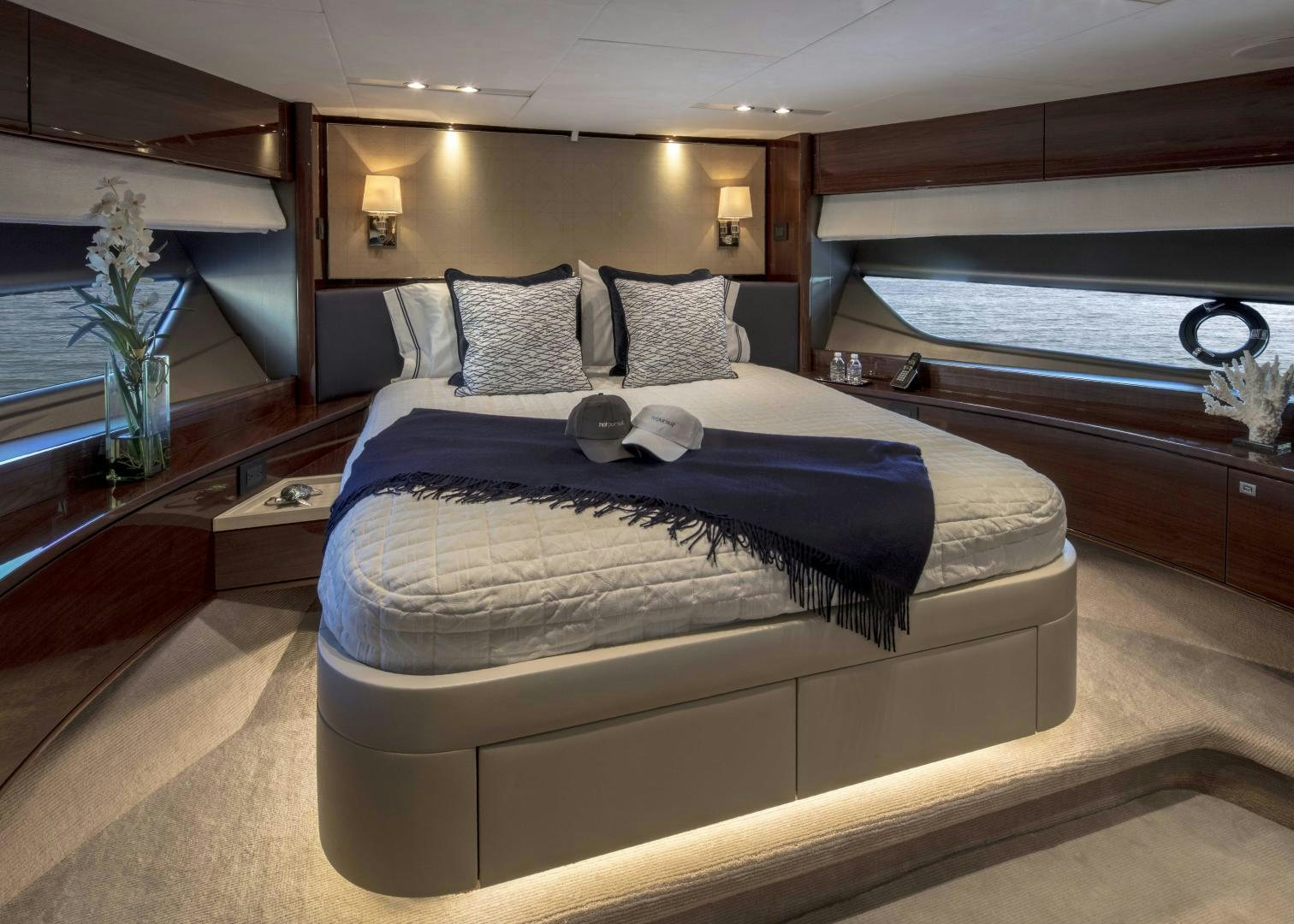 a bed with a blue blanket aboard HOT PURSUIT Yacht for Sale