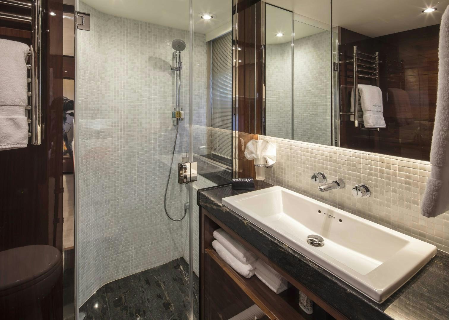 a bathroom with a sink and a shower aboard HOT PURSUIT Yacht for Sale