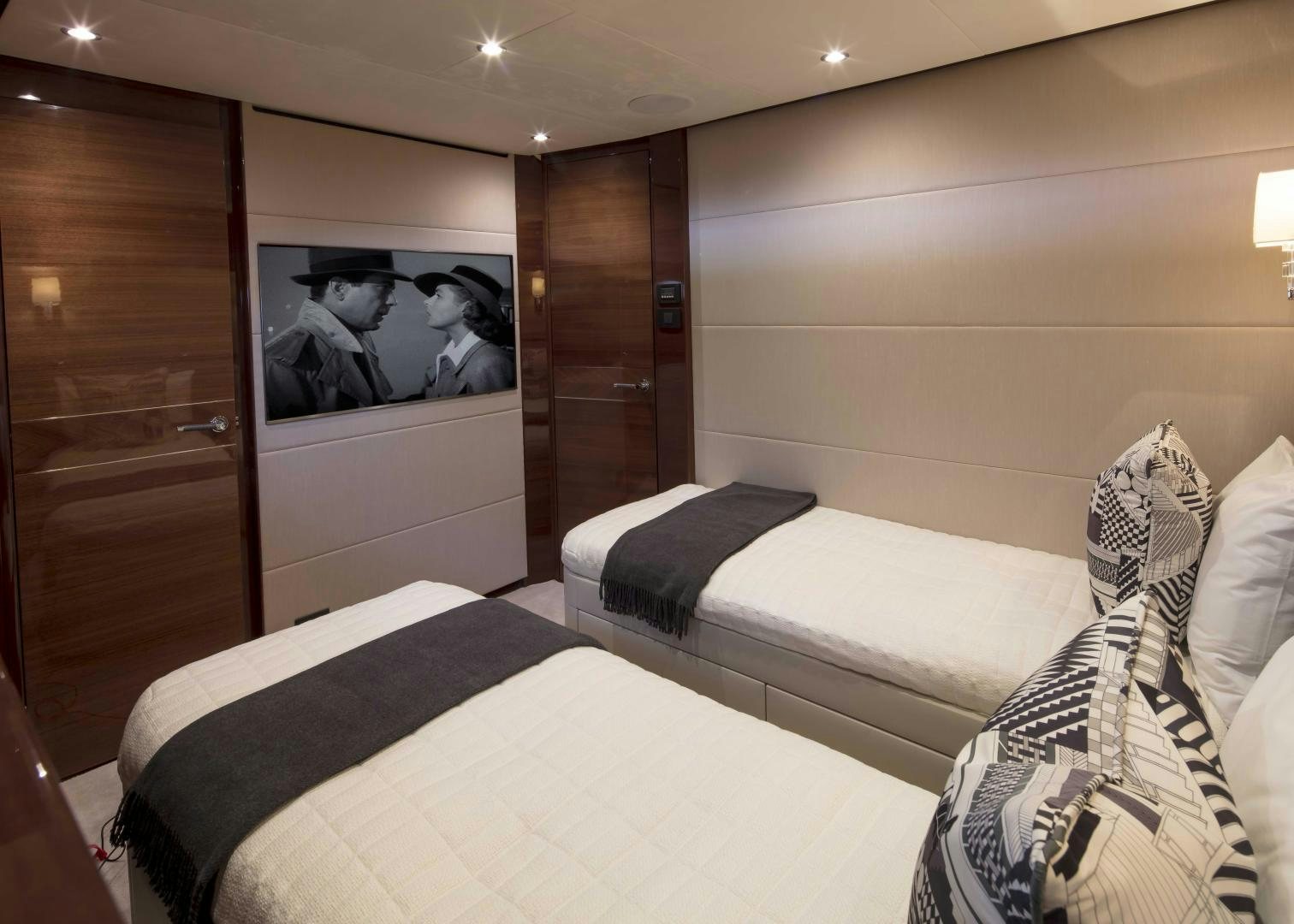 a room with a bed and a wood door aboard HOT PURSUIT Yacht for Sale