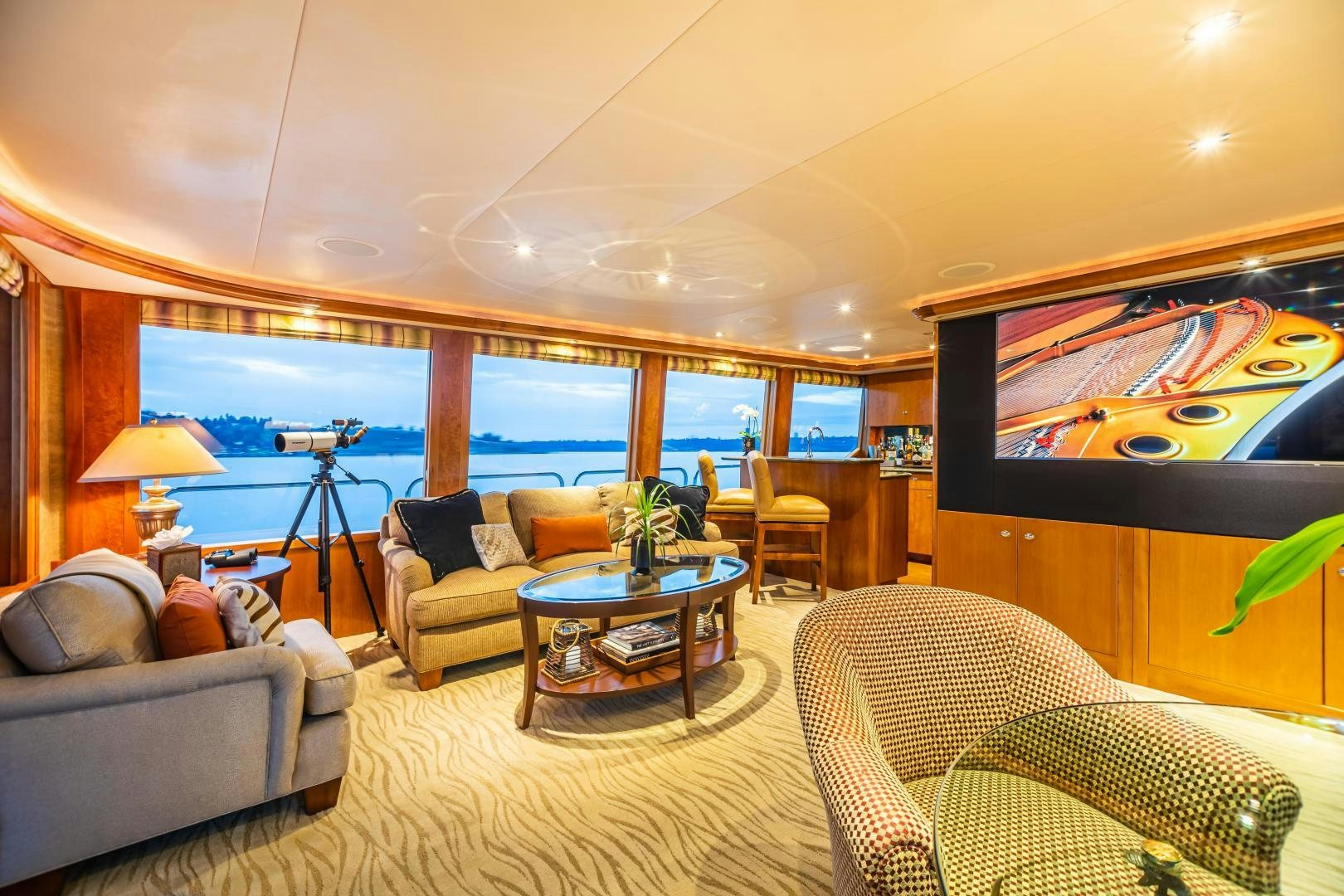 a living room with a large television aboard SERENGETI Yacht for Sale