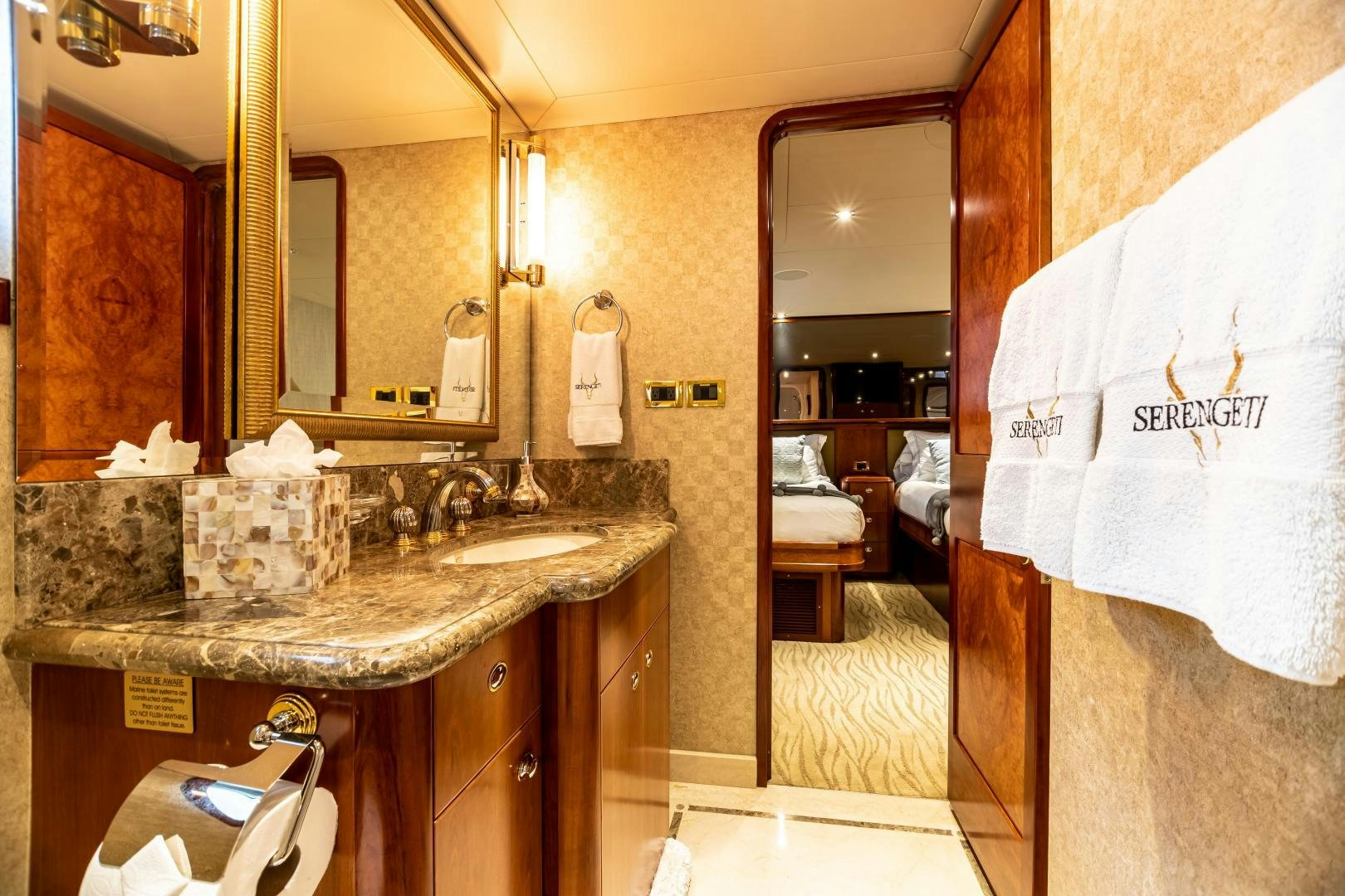 a bathroom with a countertop sink and mirror aboard SERENGETI Yacht for Sale