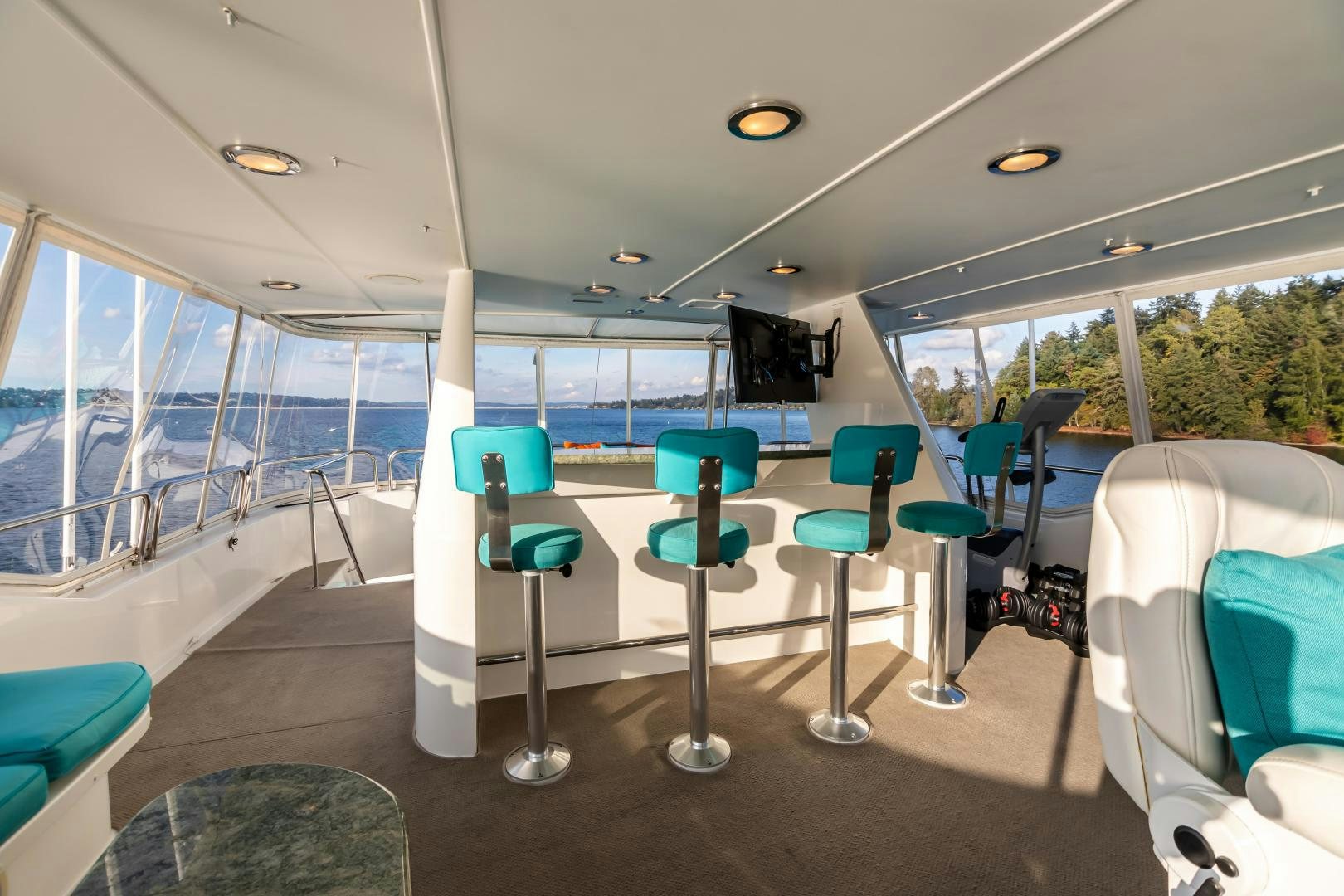 a room with chairs and tables aboard SERENGETI Yacht for Sale