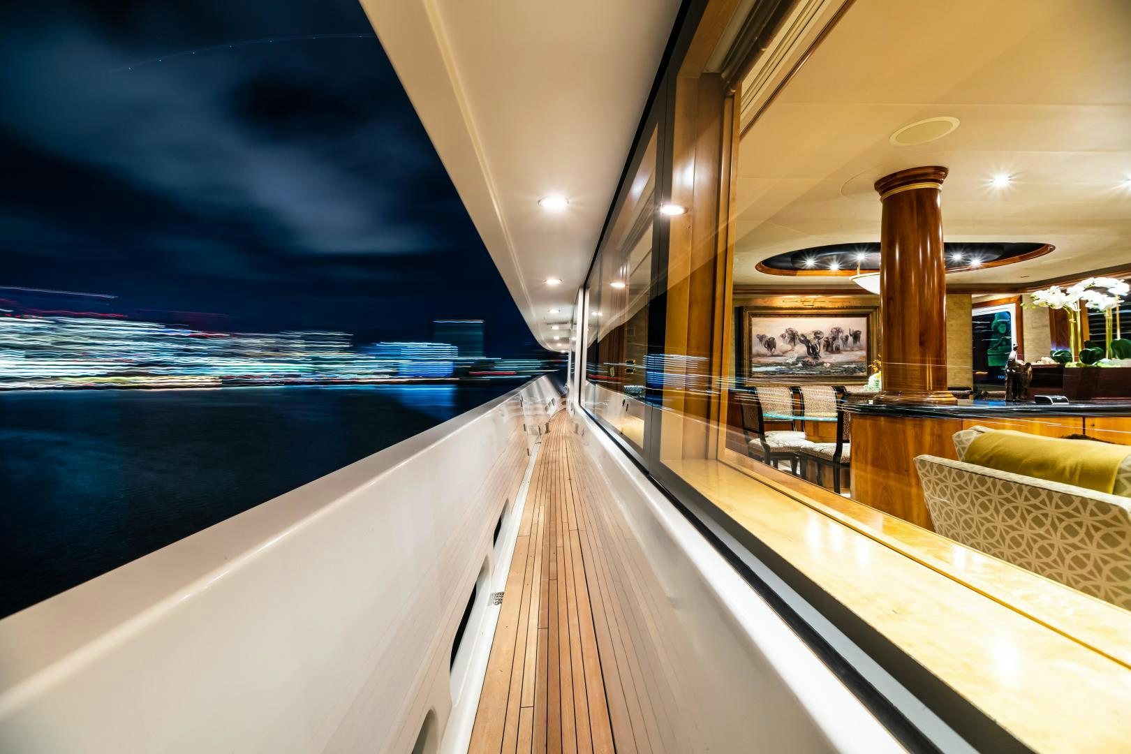 a large room with a wood floor and a large statue on the wall aboard SERENGETI Yacht for Sale