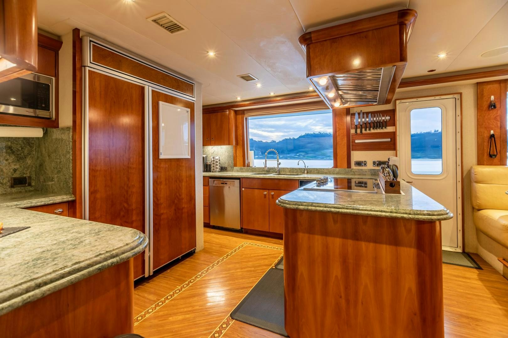 a kitchen with wooden cabinets aboard SERENGETI Yacht for Sale