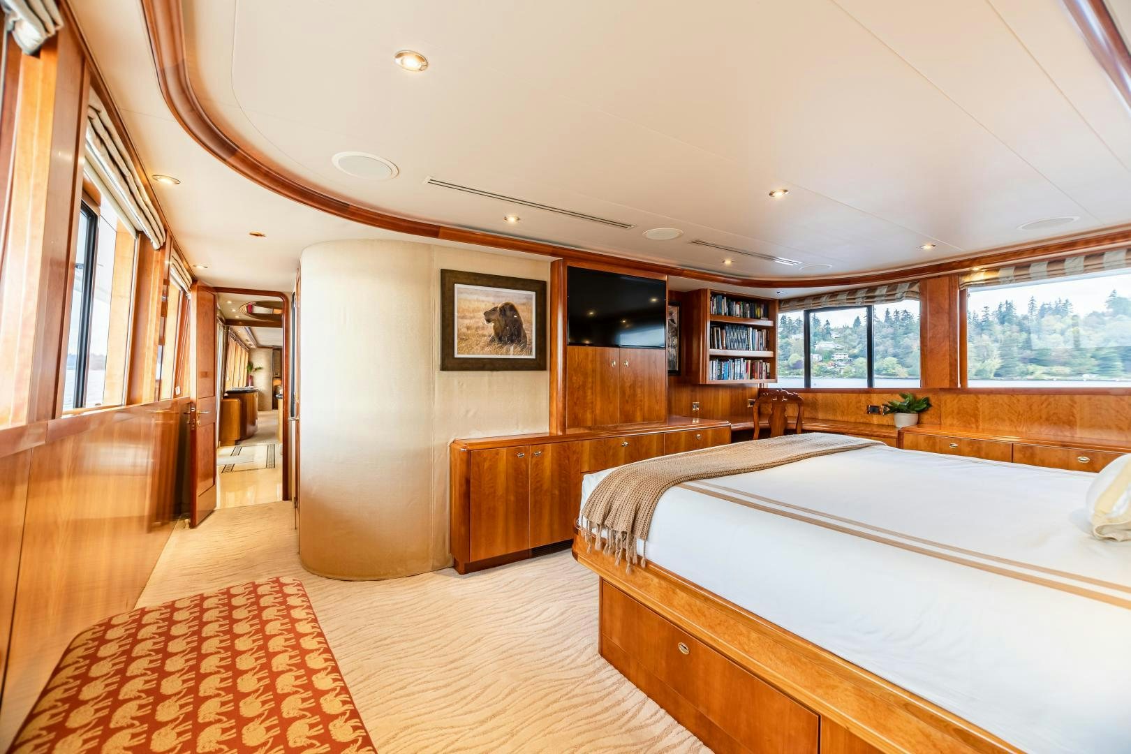 a large room with a bed and a window aboard SERENGETI Yacht for Sale