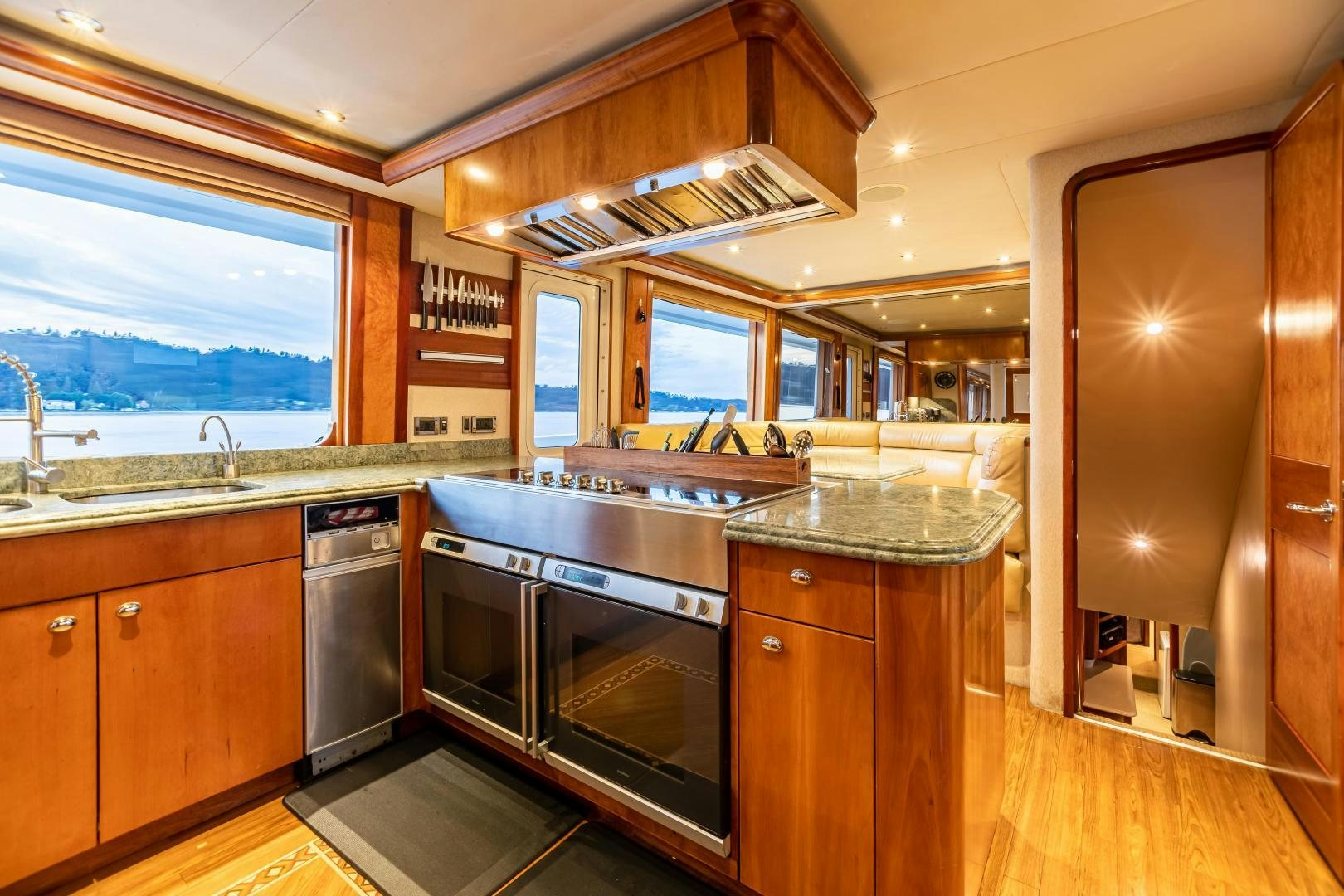 a kitchen with wooden cabinets aboard SERENGETI Yacht for Sale
