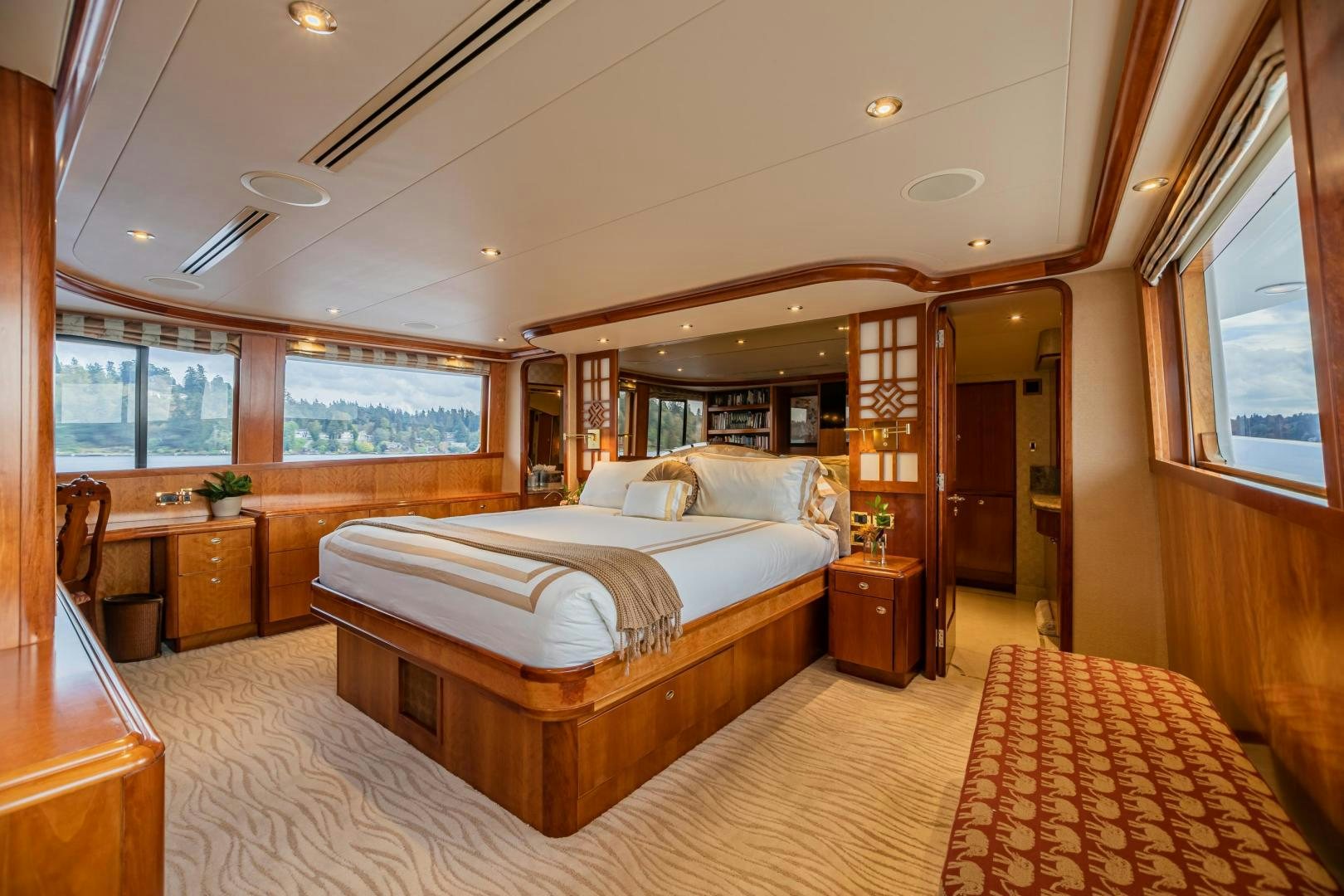 a large bedroom with a large bed aboard SERENGETI Yacht for Sale