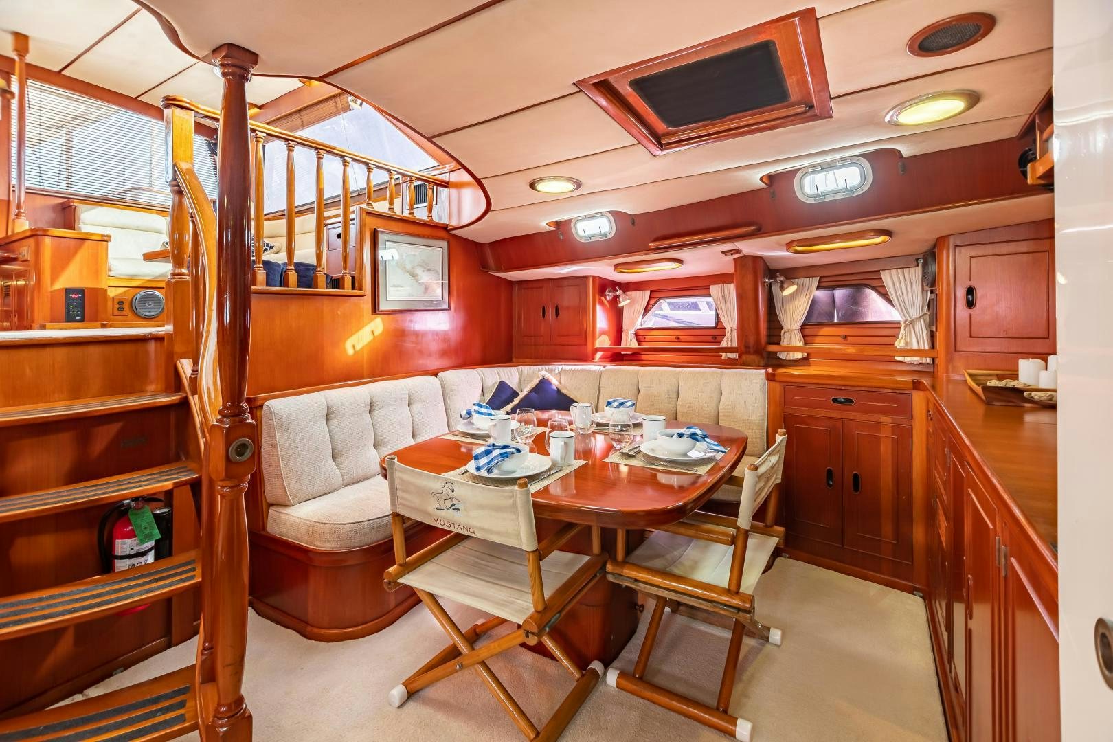 a small kitchen with a dining table aboard MUSTANG Yacht for Sale