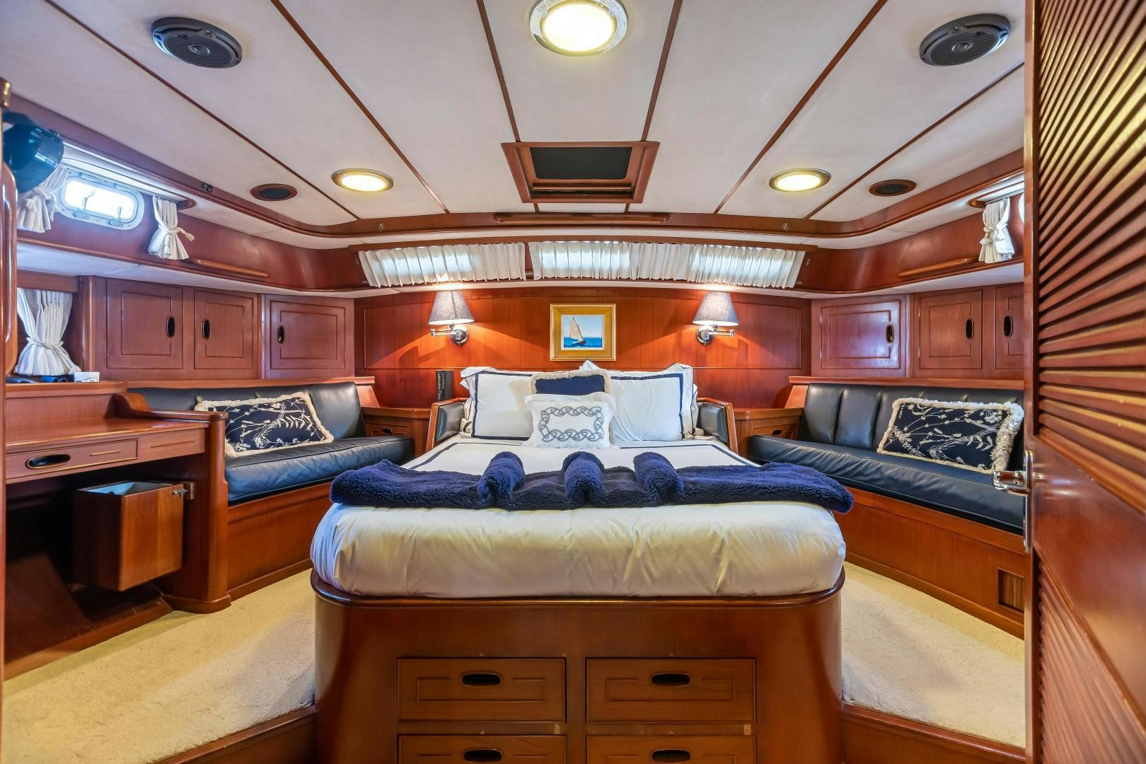 a room with a bed and a desk aboard MUSTANG Yacht for Sale