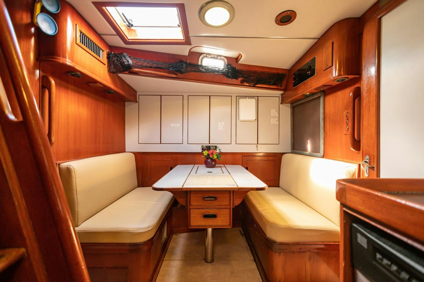 a room with a table and chairs aboard MUSTANG Yacht for Sale