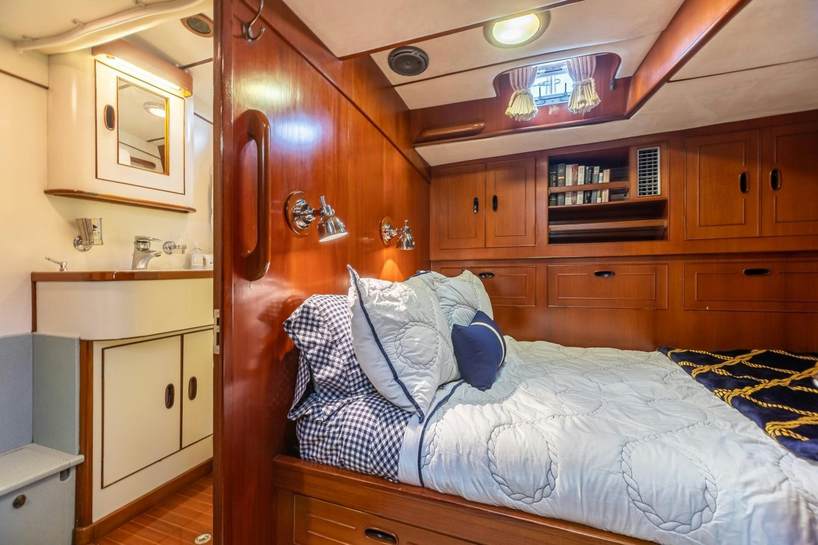 a bedroom with a wood cabinet aboard MUSTANG Yacht for Sale