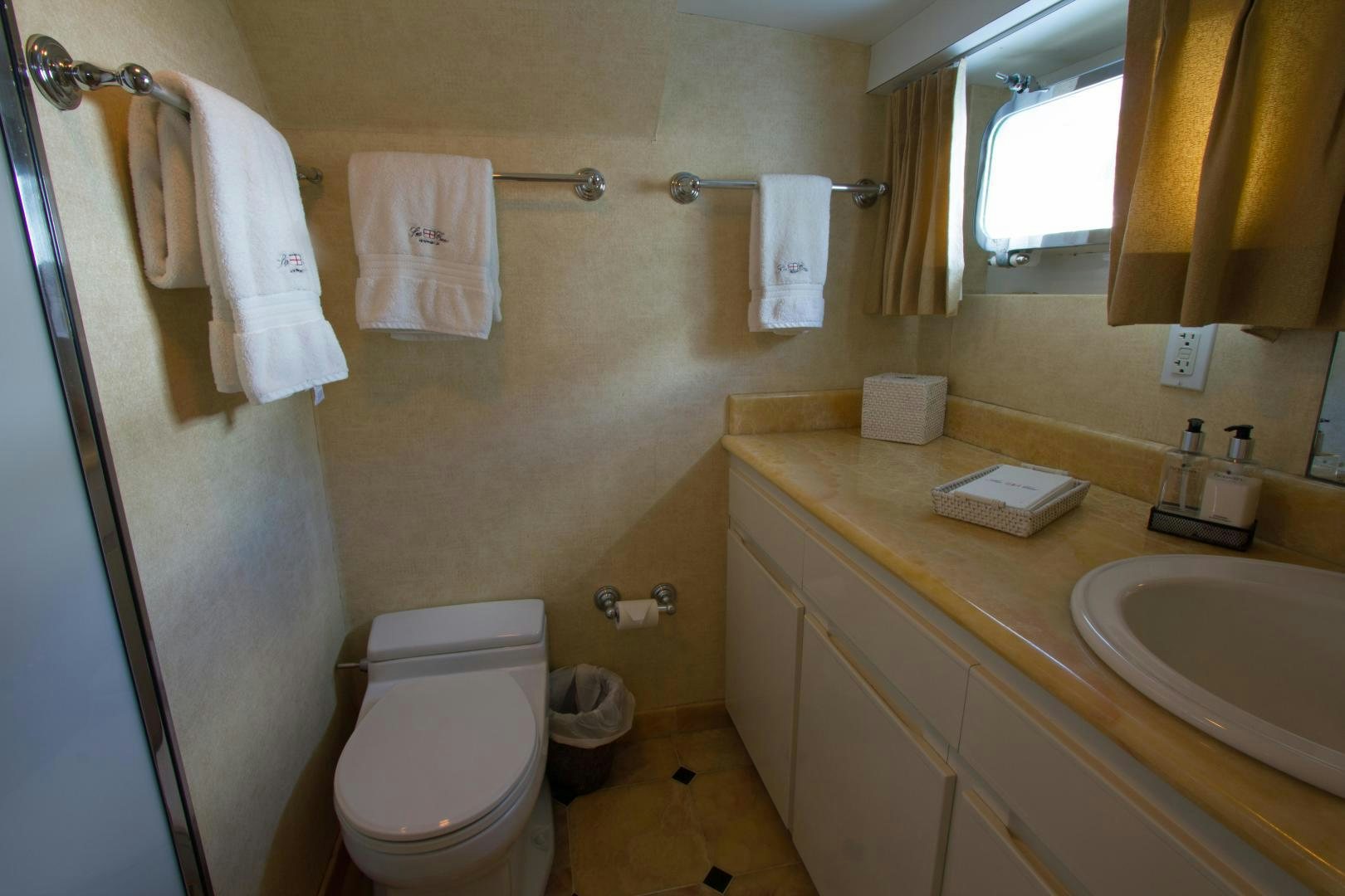 a bathroom with a toilet and sink aboard SEA CZAR Yacht for Sale