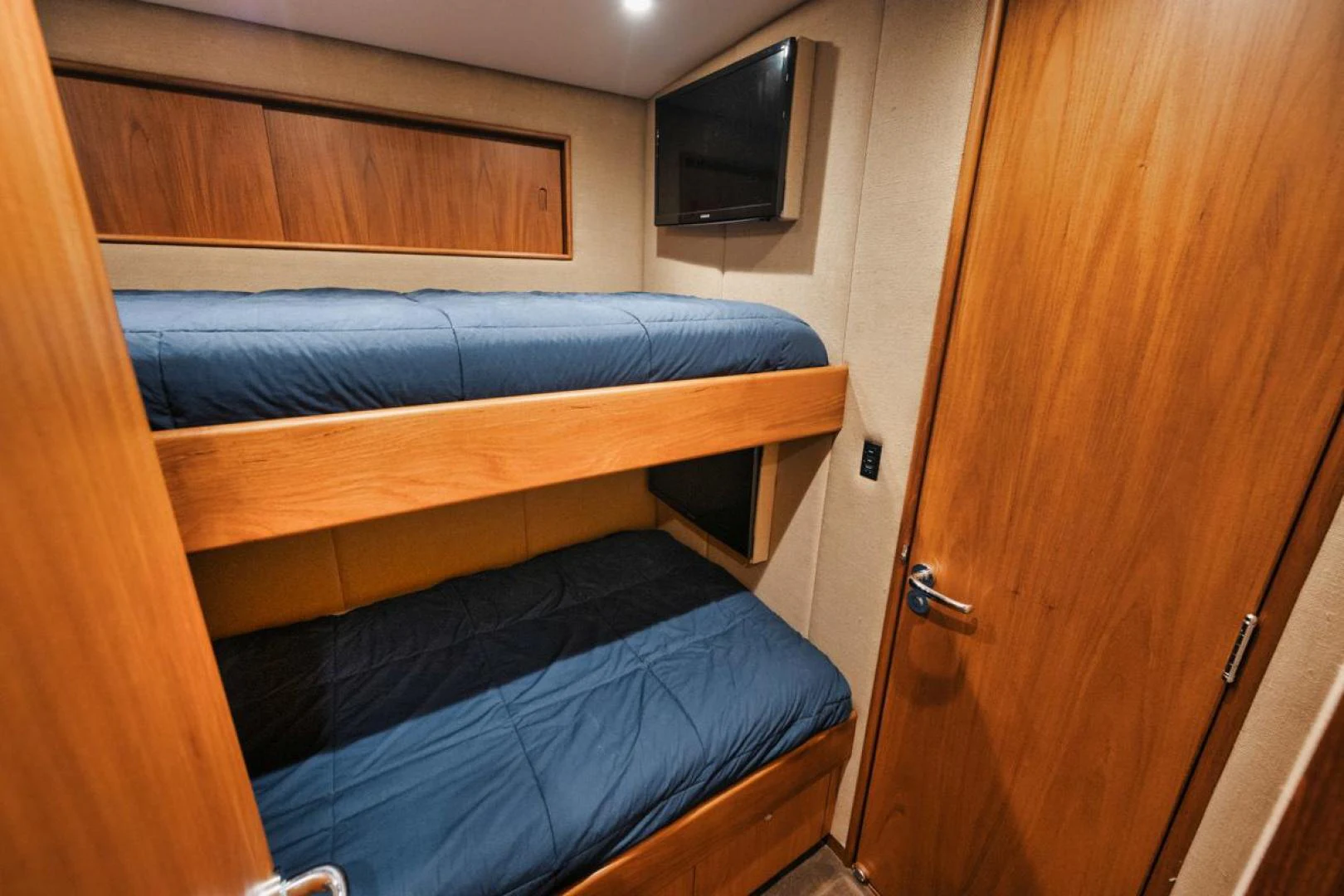 a bedroom with a wood cabinet aboard OWL'S NEST Yacht for Sale