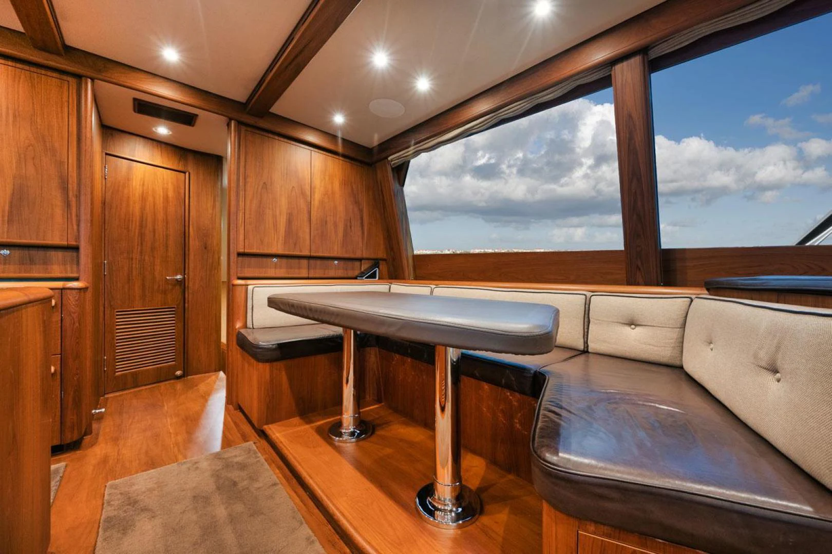 a room with a table and a couch aboard OWL'S NEST Yacht for Sale