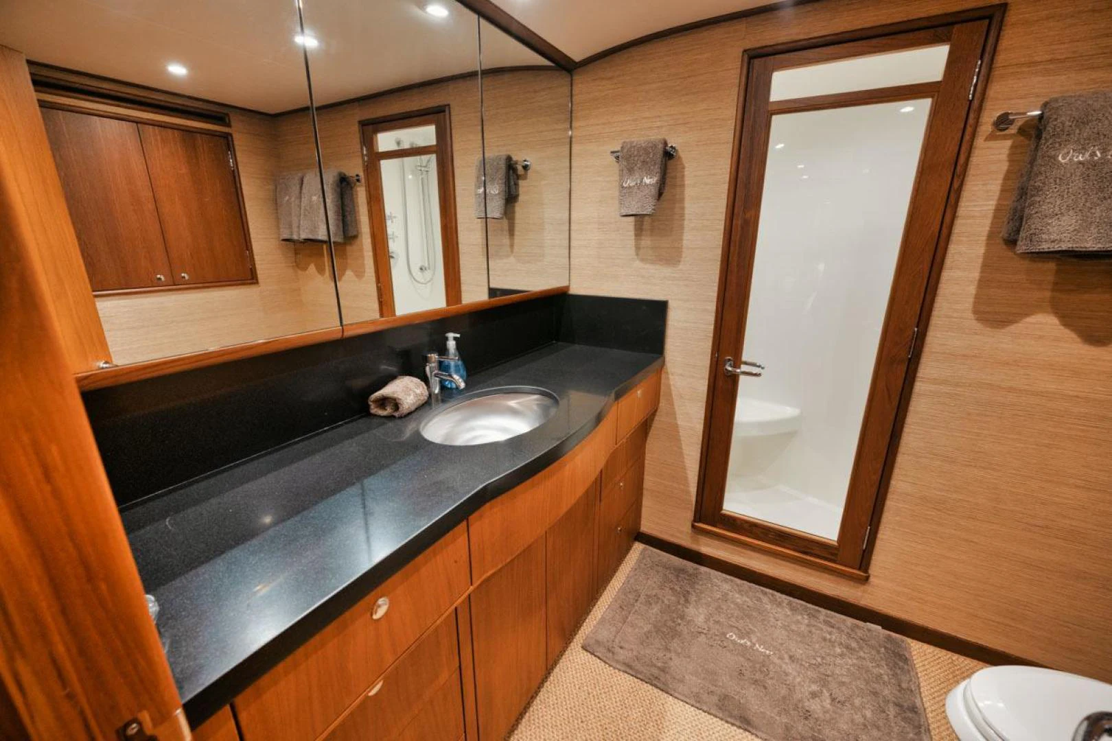 a bathroom with a large mirror aboard OWL'S NEST Yacht for Sale