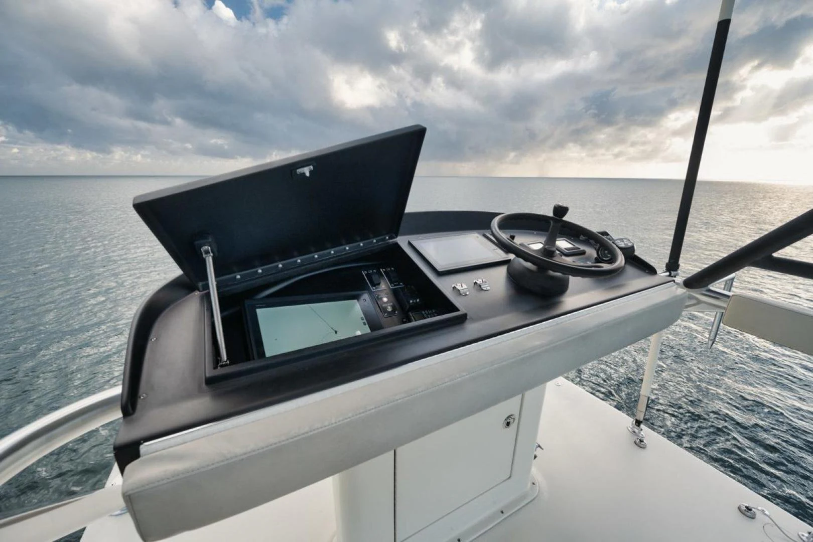 a boat with a steering wheel and a boat in the water aboard OWL'S NEST Yacht for Sale