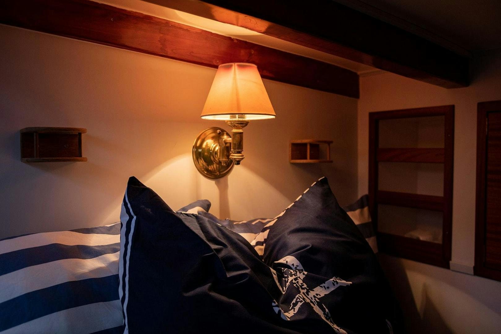 a lamp on a bed aboard SKYTHIA Yacht for Sale