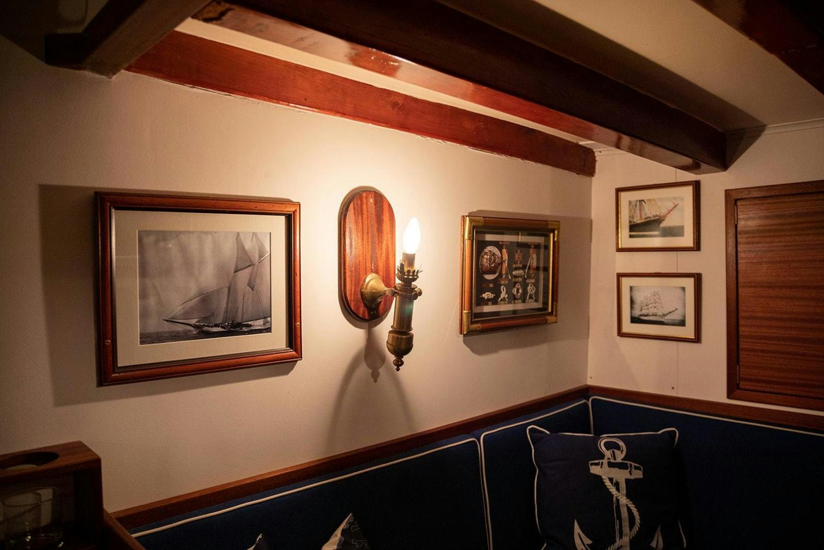 a wall with pictures on it aboard SKYTHIA Yacht for Sale