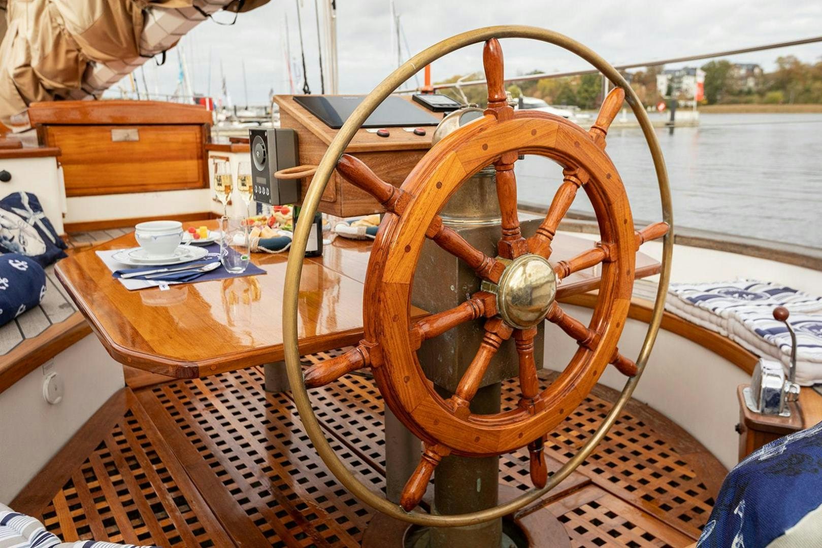 a wooden steering wheel on a boat aboard SKYTHIA Yacht for Sale