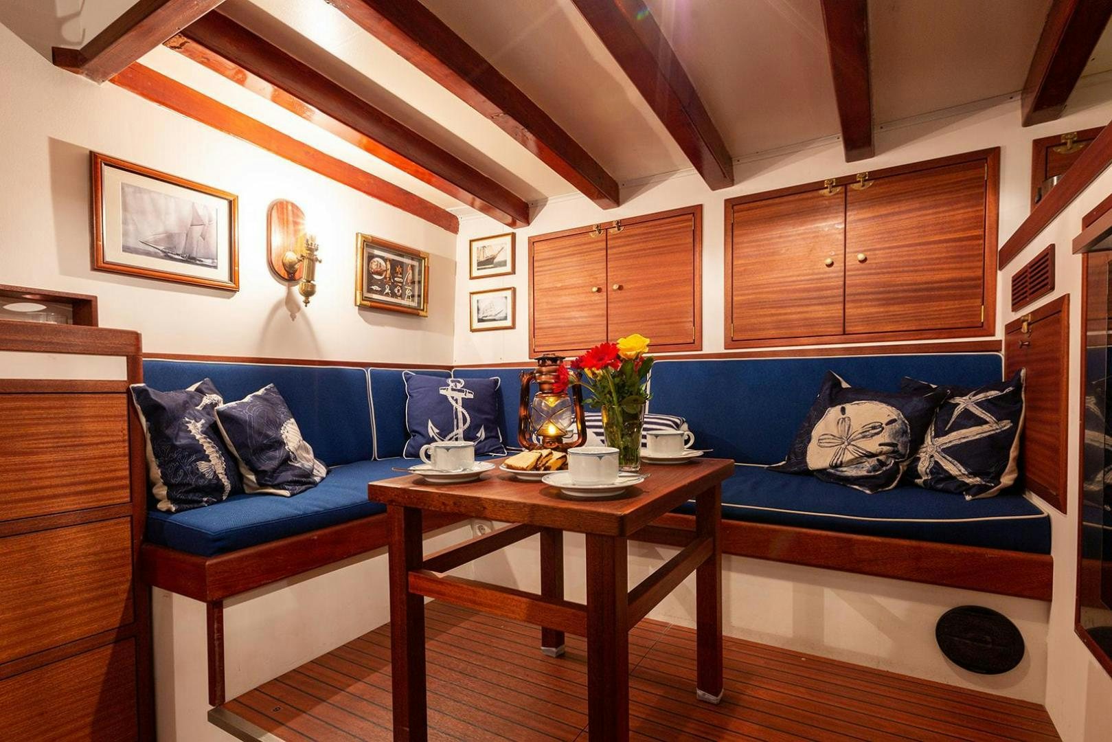 a living room with a blue couch aboard SKYTHIA Yacht for Sale
