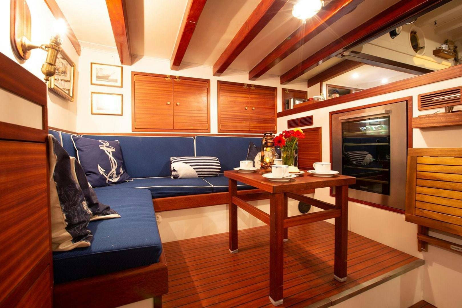 a living room with a blue couch aboard SKYTHIA Yacht for Sale