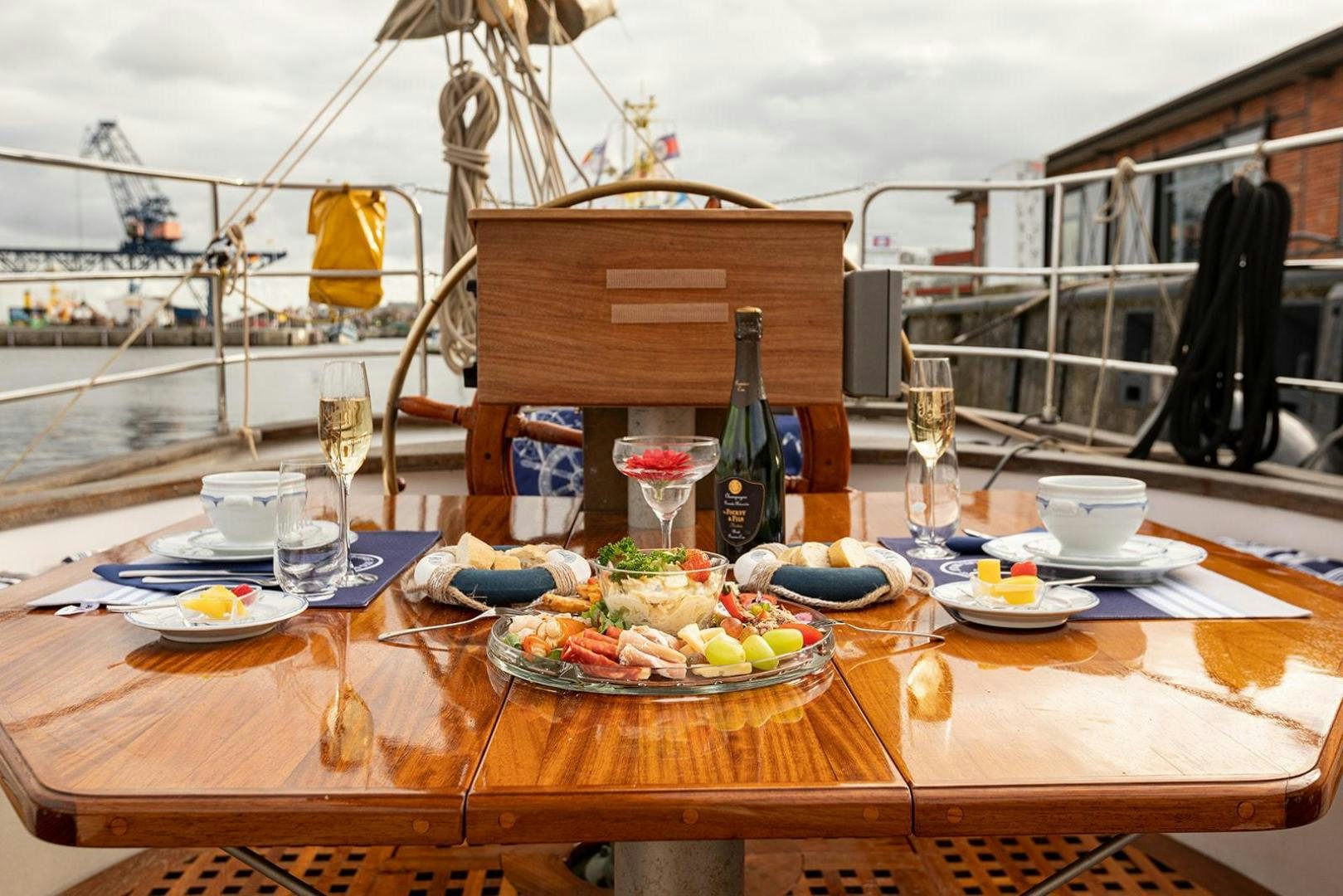 a table with food and wine aboard SKYTHIA Yacht for Sale