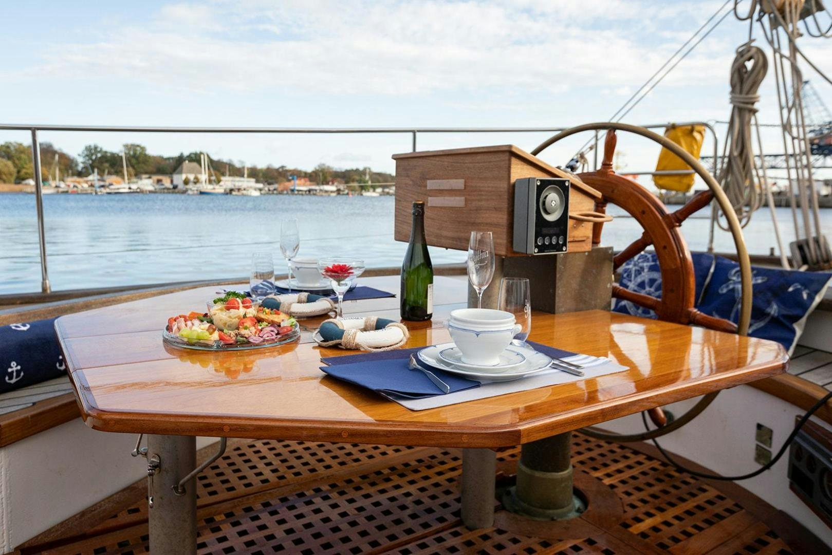 a table with food and drinks on it aboard SKYTHIA Yacht for Sale