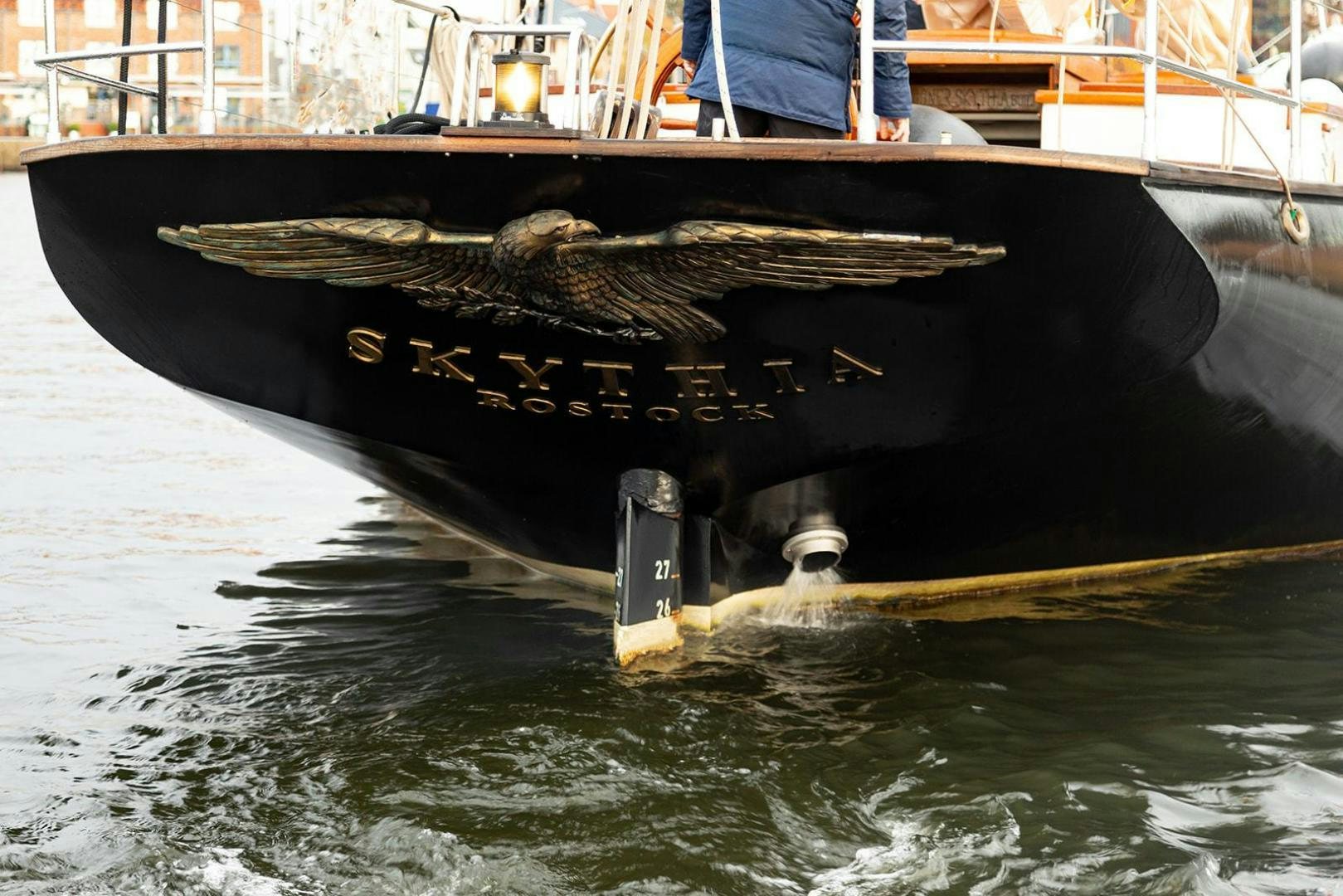 a black boat on water aboard SKYTHIA Yacht for Sale