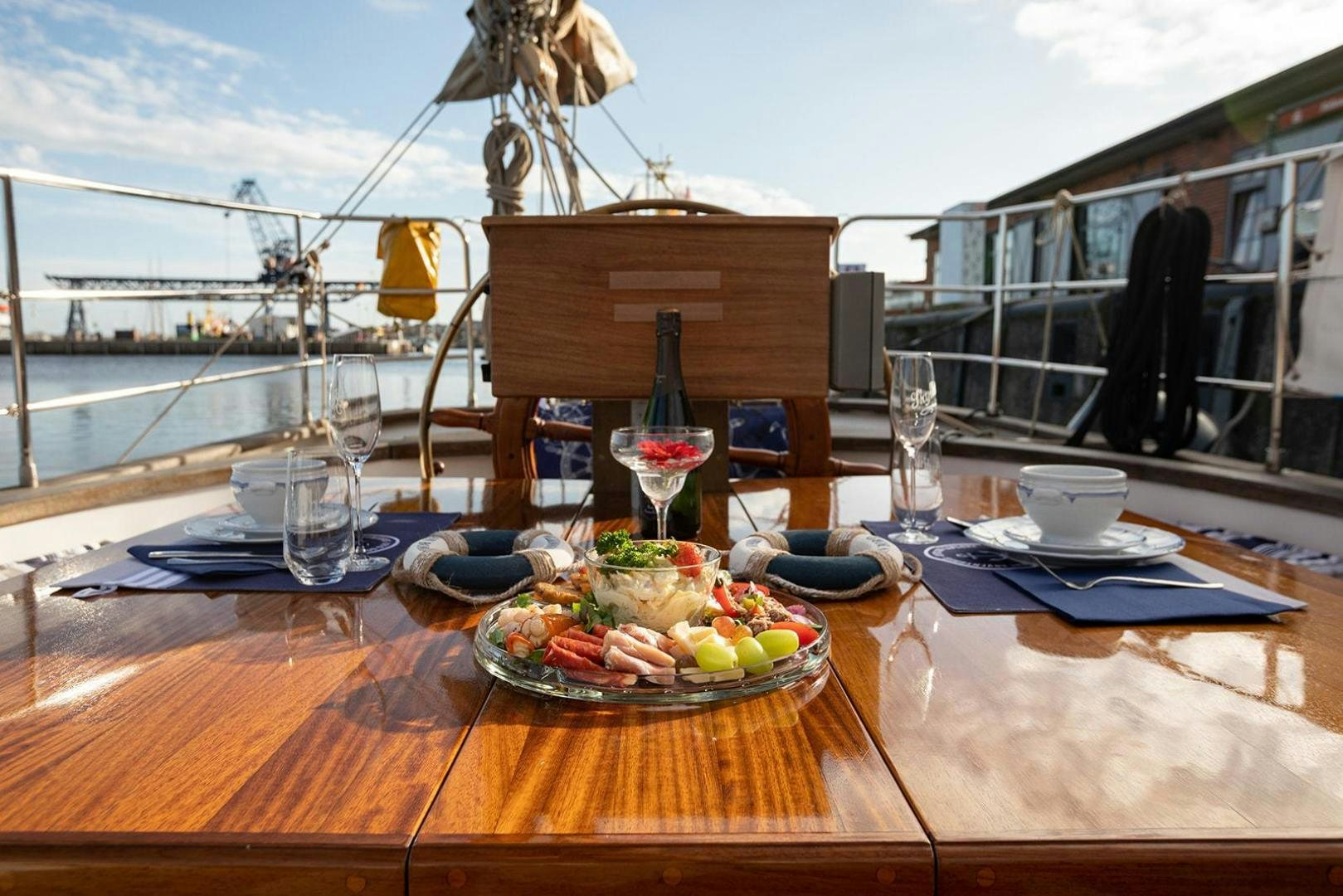 a table with food and drinks on it aboard SKYTHIA Yacht for Sale