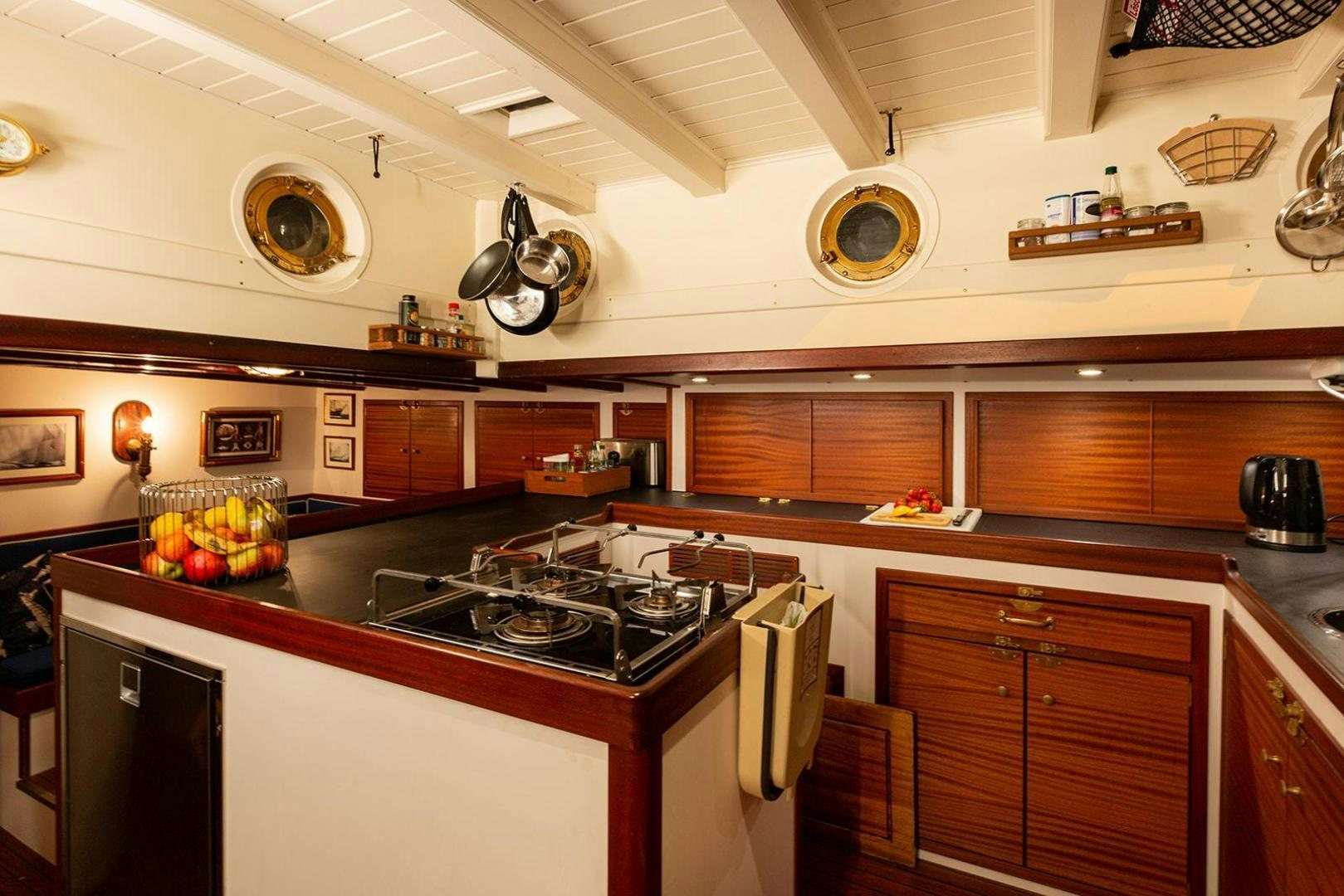 a kitchen with a stove and a pot of tomatoes aboard SKYTHIA Yacht for Sale