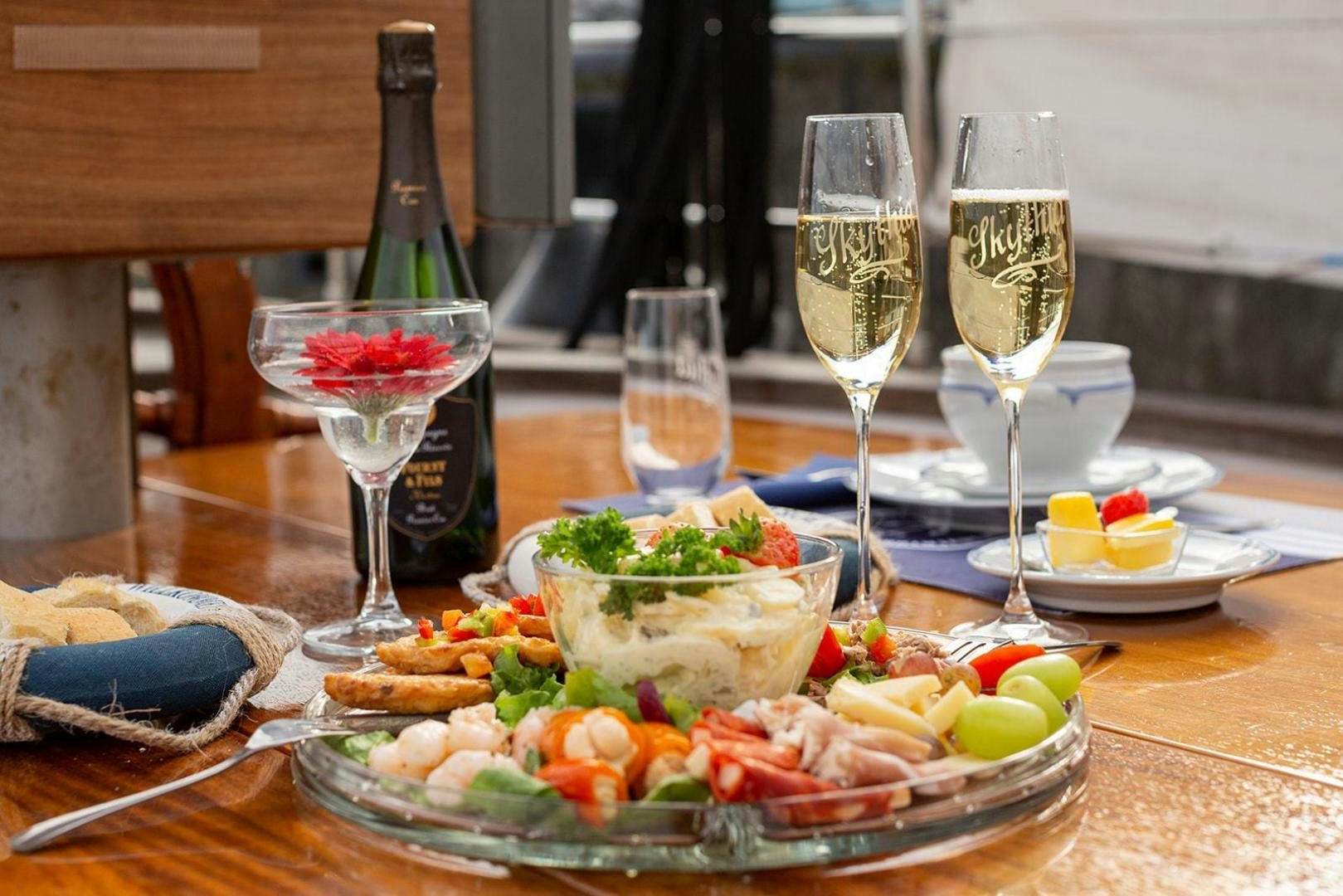 a table with food and wine aboard SKYTHIA Yacht for Sale
