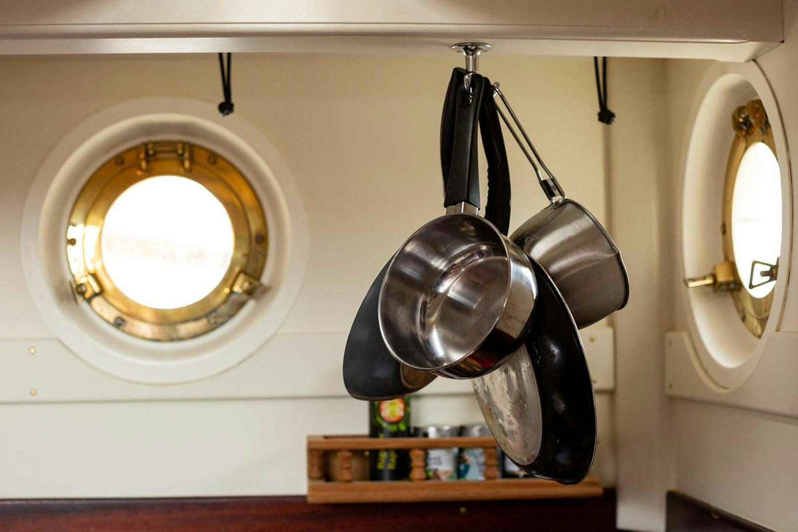 a group of pots from a wall aboard SKYTHIA Yacht for Sale