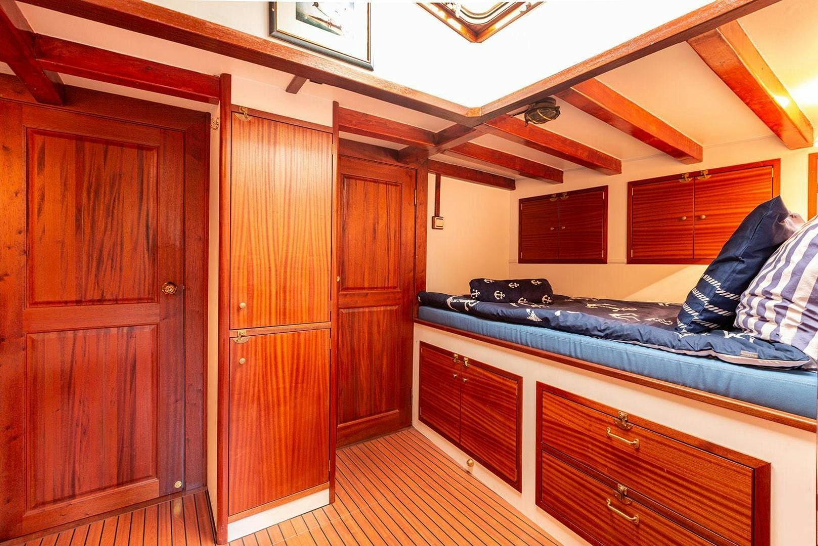 a kitchen with wooden cabinets aboard SKYTHIA Yacht for Sale