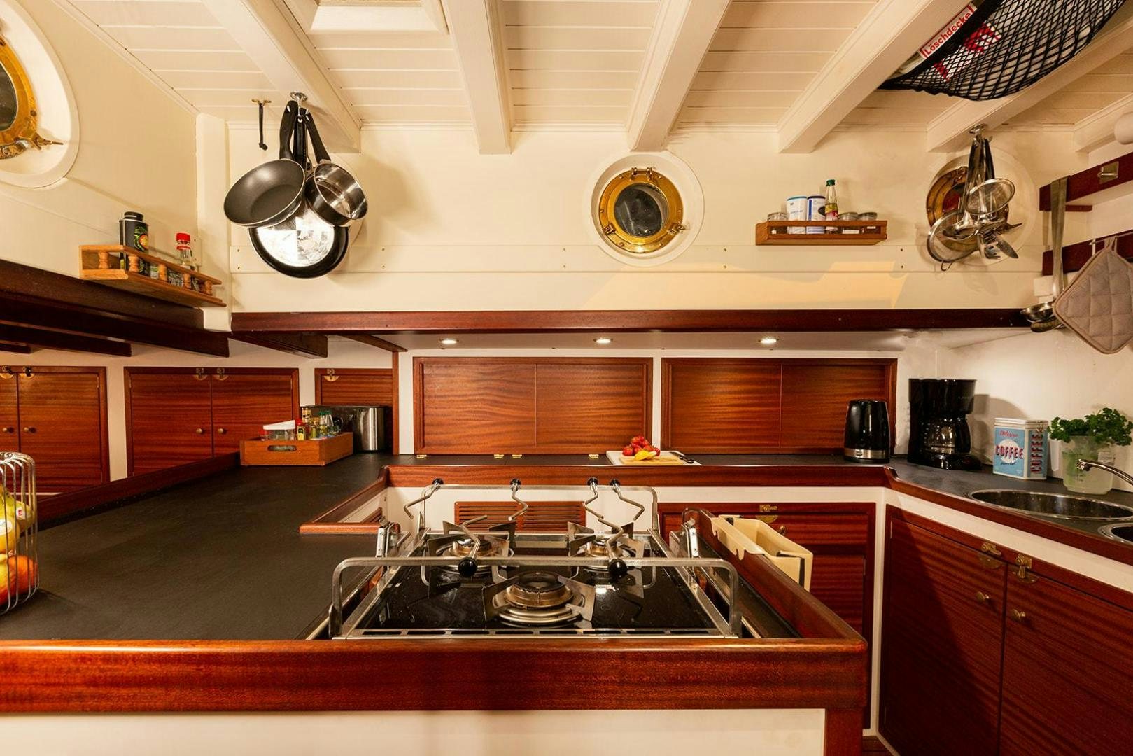 a kitchen with a large island aboard SKYTHIA Yacht for Sale