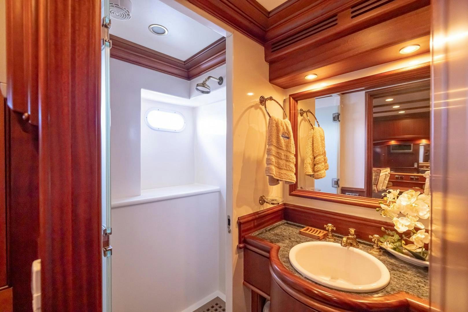 a bathroom with a sink and mirror aboard ESSENCE OF CAYMAN Yacht for Sale