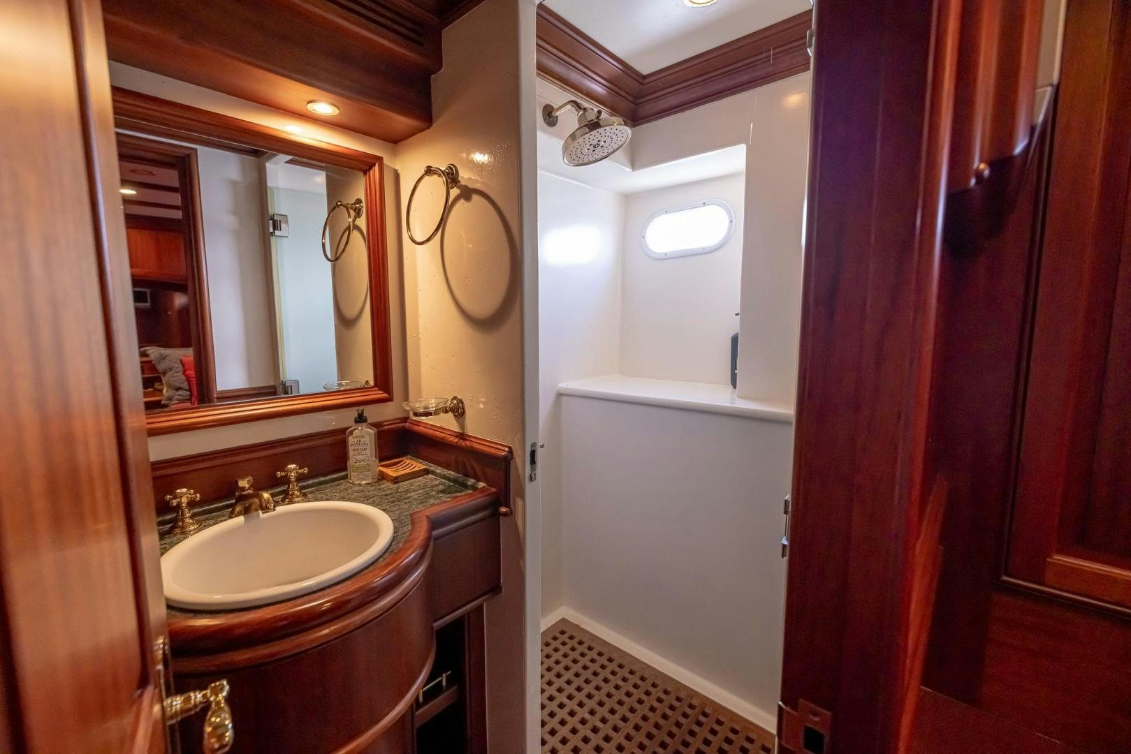 a bathroom with a sink and mirror aboard ESSENCE OF CAYMAN Yacht for Sale