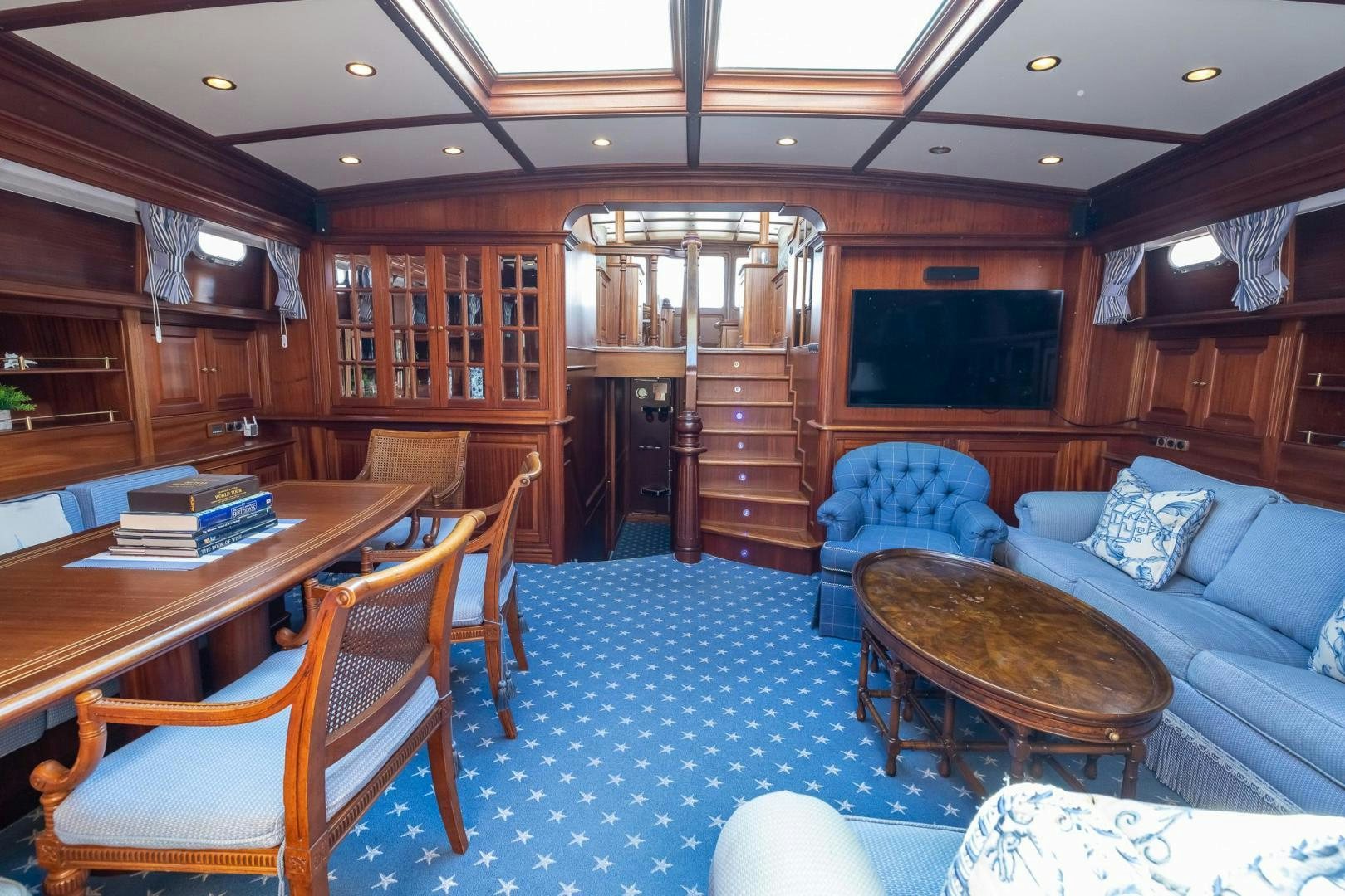 a living room with a blue floor aboard ESSENCE OF CAYMAN Yacht for Sale