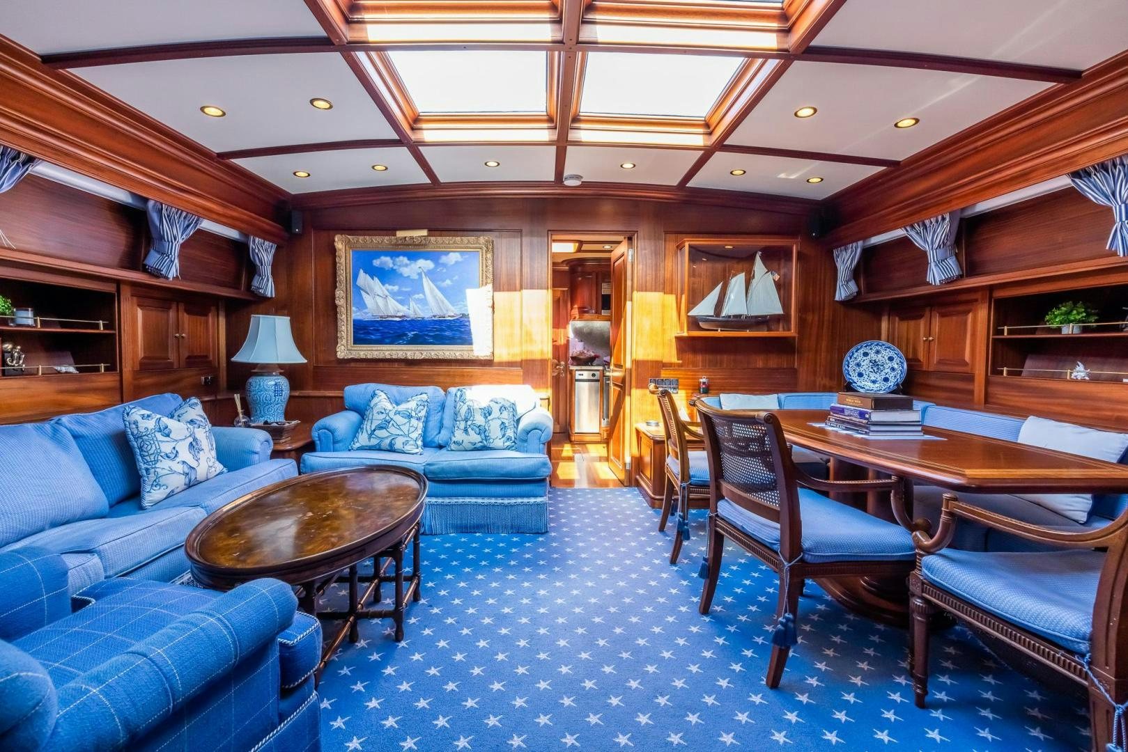 a living room with a couch and a table aboard ESSENCE OF CAYMAN Yacht for Sale