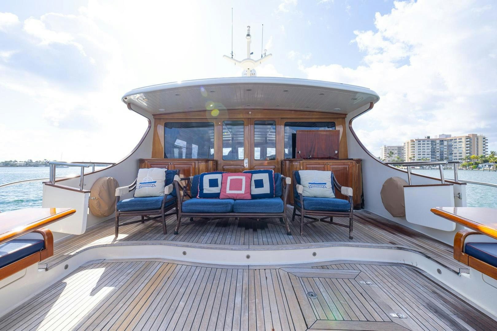 a deck with chairs and a table on it aboard ESSENCE OF CAYMAN Yacht for Sale