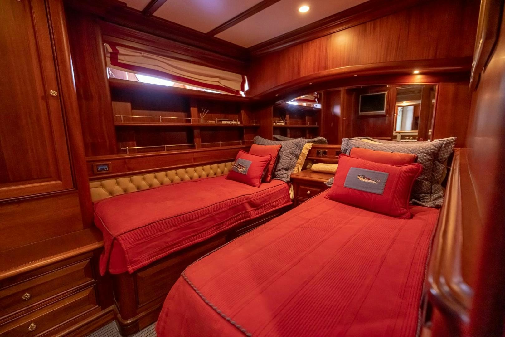 a room with a bed and a red bed aboard ESSENCE OF CAYMAN Yacht for Sale