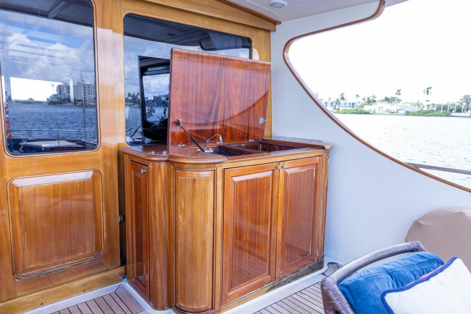 a kitchen with wooden cabinets aboard ESSENCE OF CAYMAN Yacht for Sale