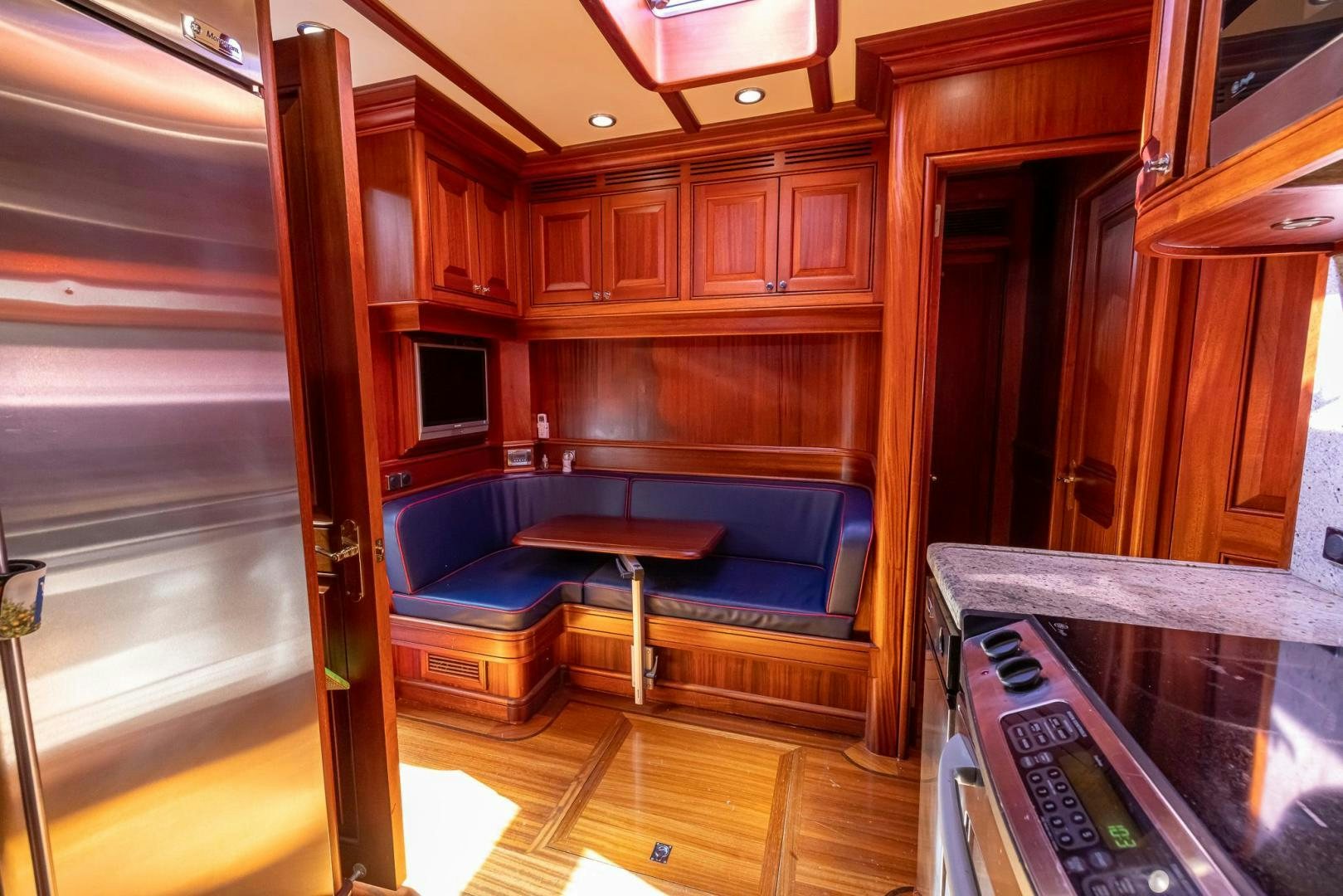 a room with a bed and a table aboard ESSENCE OF CAYMAN Yacht for Sale