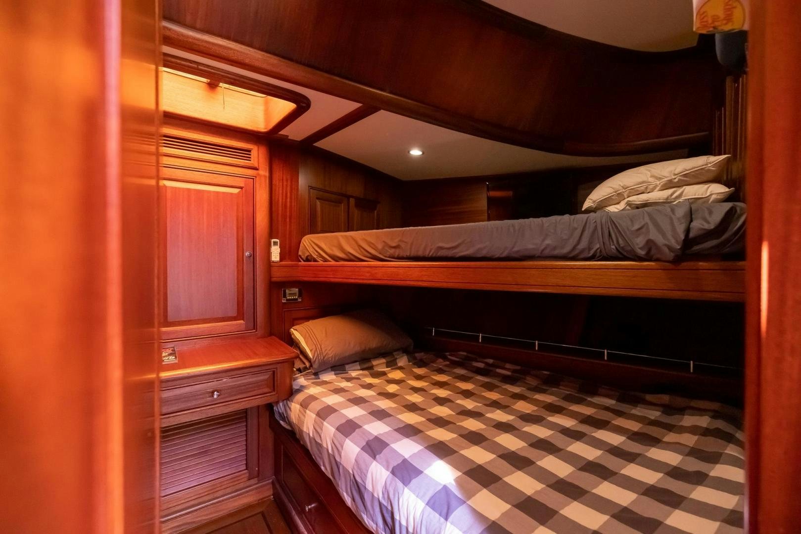 a room with a bed and a striped rug aboard ESSENCE OF CAYMAN Yacht for Sale