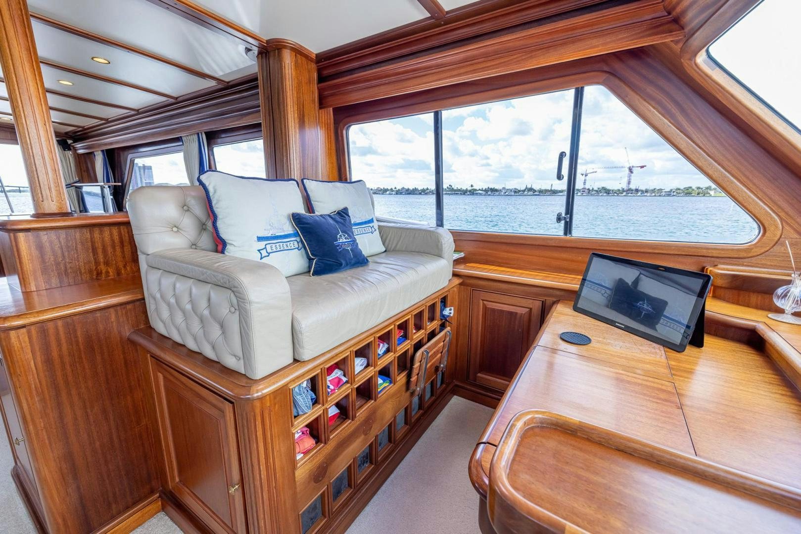 a living room with a couch and a television aboard ESSENCE OF CAYMAN Yacht for Sale