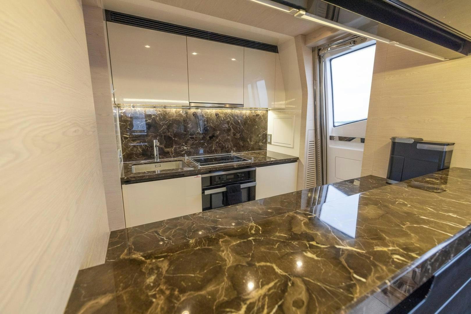 a kitchen with a marble counter top aboard HAPPY HOURS Yacht for Sale