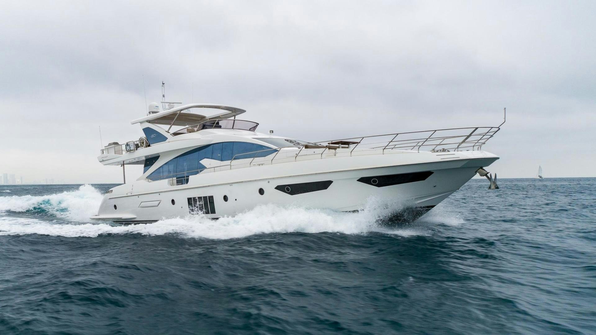 a white yacht in the ocean aboard HAPPY HOURS Yacht for Sale