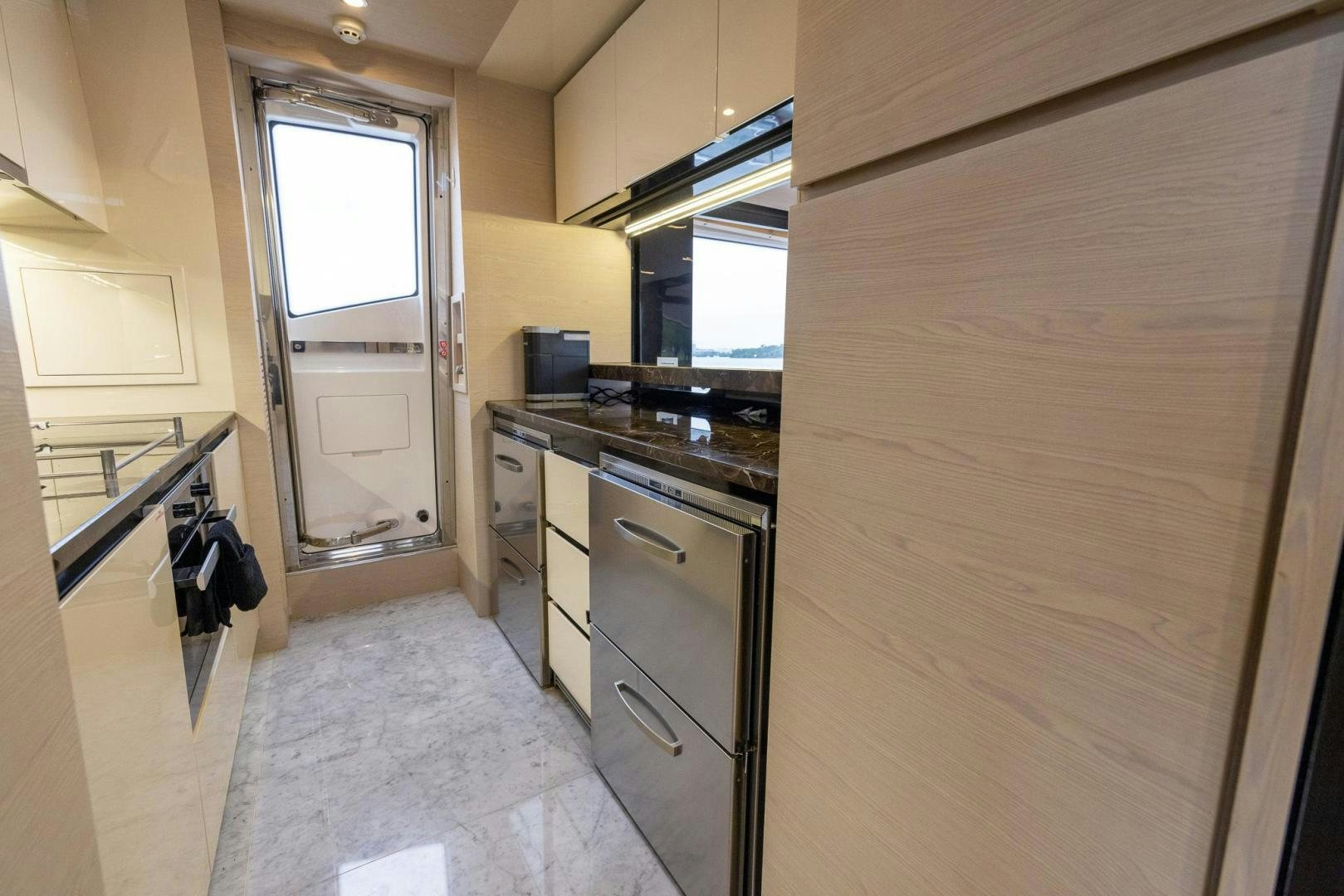 a kitchen with a large wooden door aboard HAPPY HOURS Yacht for Sale
